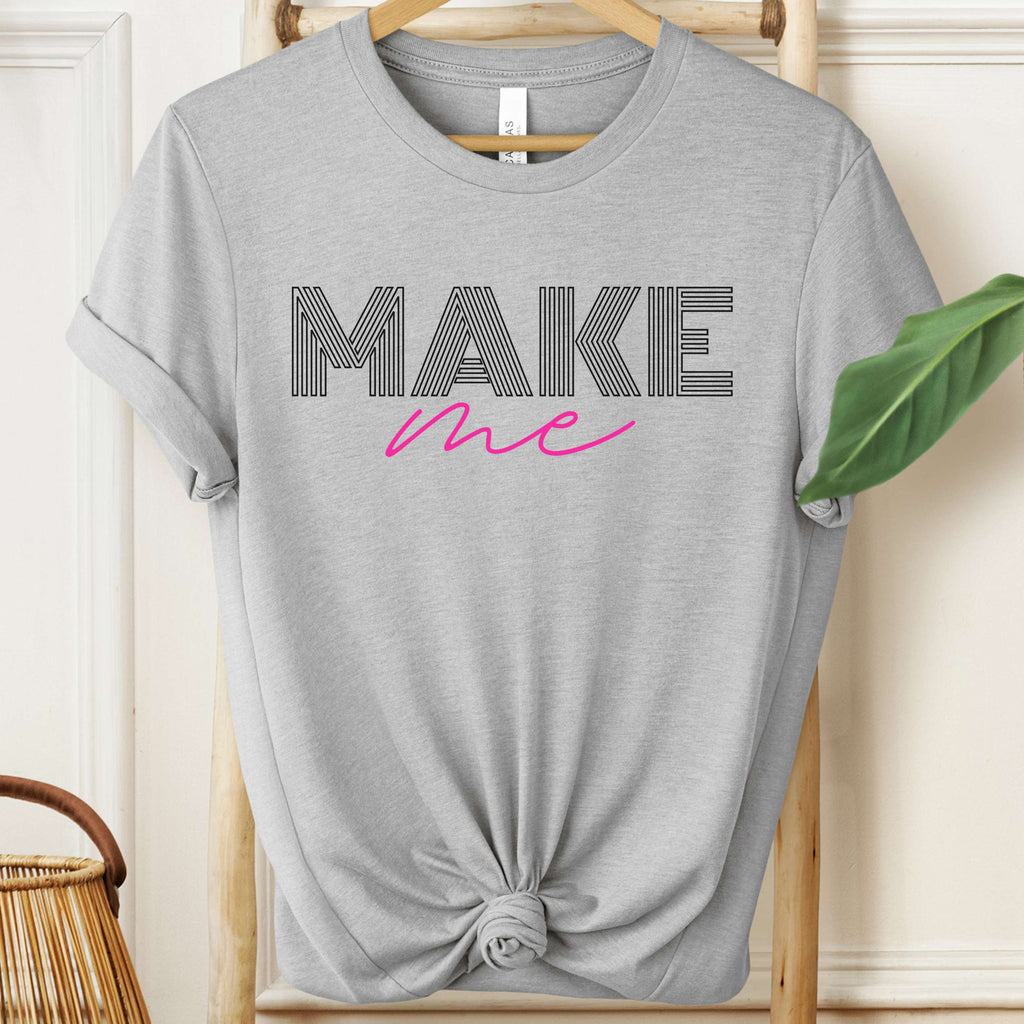 Gray t-shirt with 'MAKE me' text on a hanger
