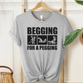 Begging For A Pegging T-Shirt in Athletic Heather gray with bold black graphic print, unisex adult humor shirt.