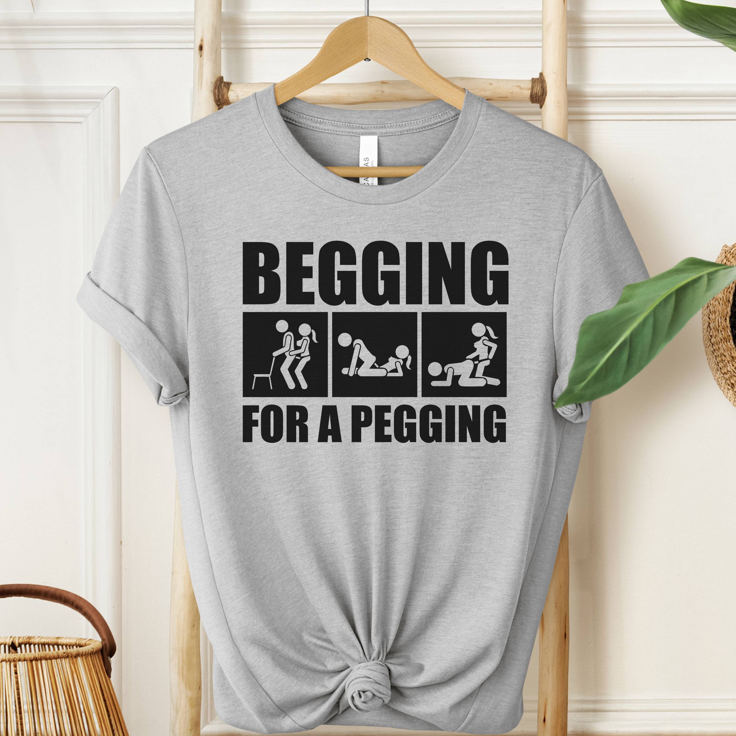 Begging For A Pegging T-Shirt in Athletic Heather gray with bold black graphic print, unisex adult humor shirt.