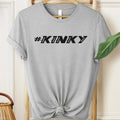 Gray t-shirt with '#KINKY' text on a hanger against a neutral background