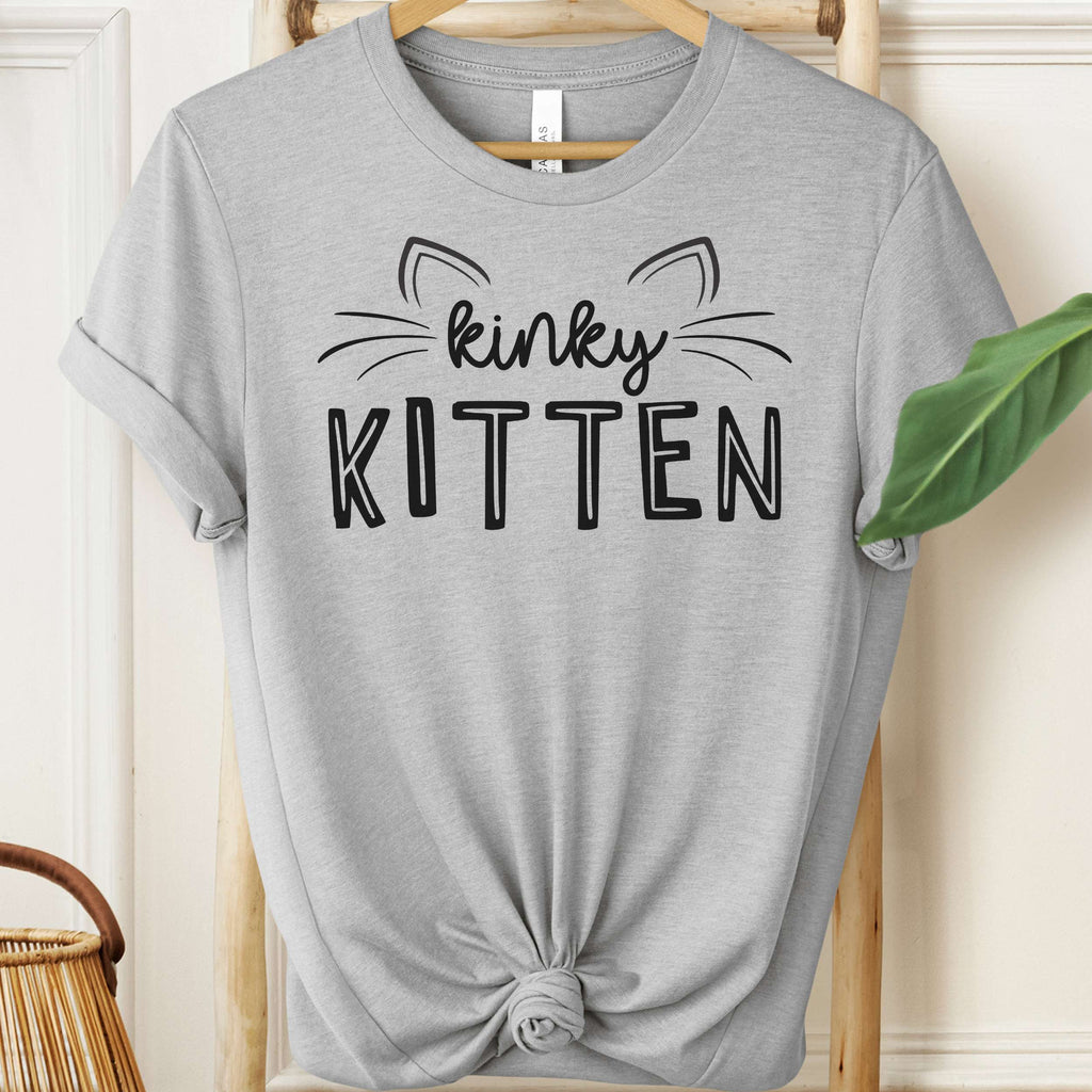 Gray t-shirt with 'kinky KITTEN' text on a hanger.
