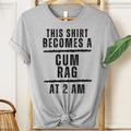 Gray t-shirt with humorous text on a hanger against a neutral background