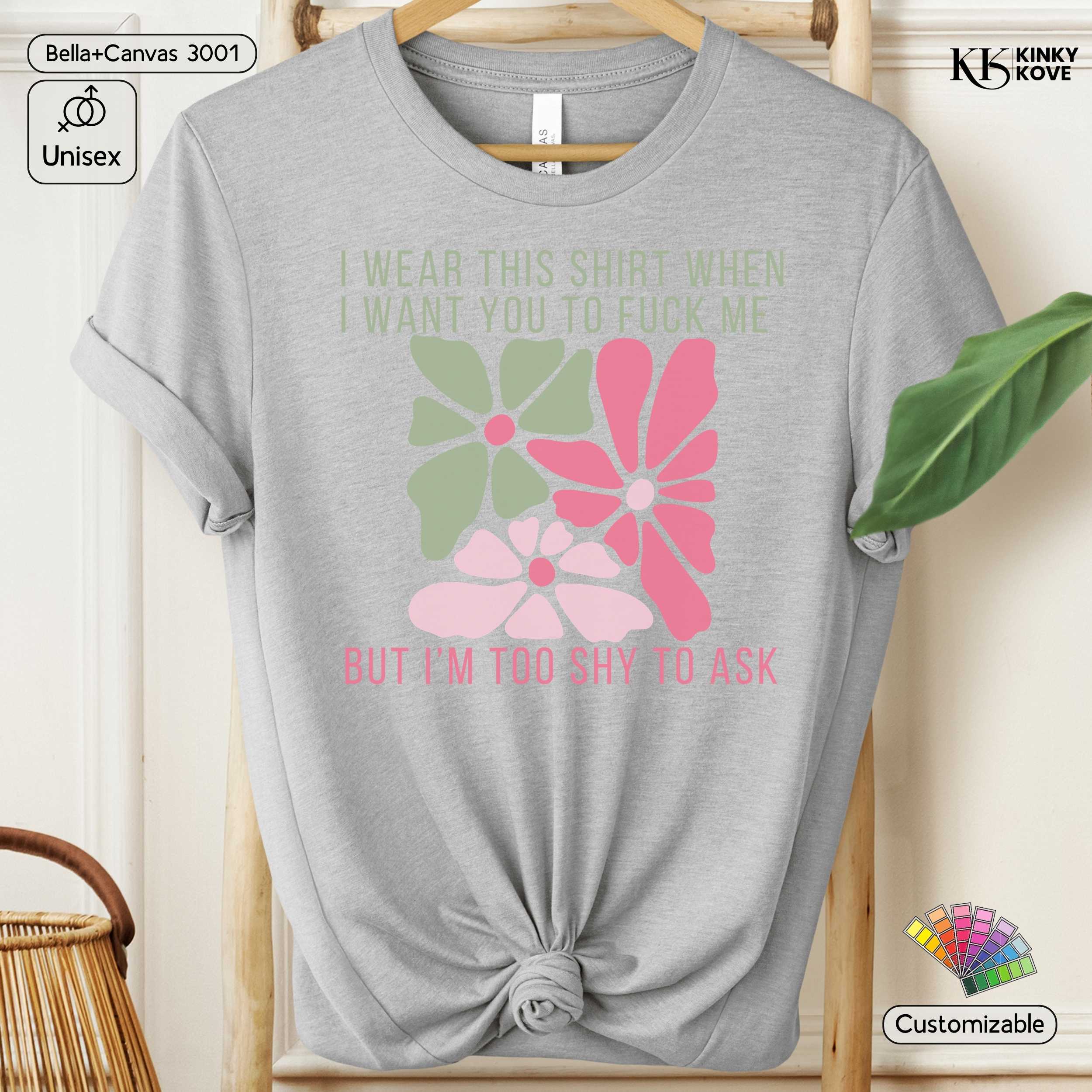 Gray t-shirt with floral design and text on a hanger