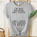 Gray t-shirt with humorous text design on a hanger.