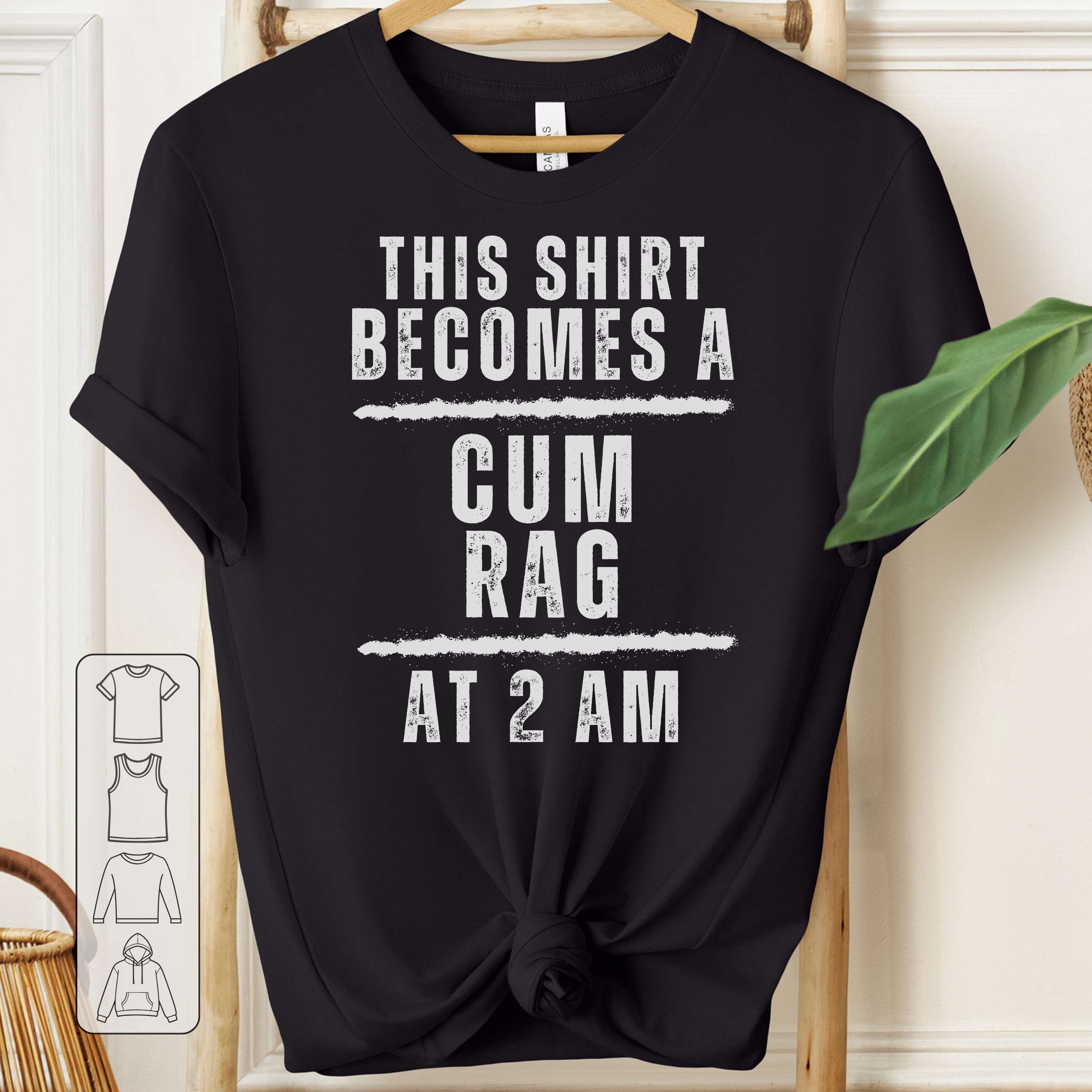 Black t-shirt with white text on a hanger against a neutral background
