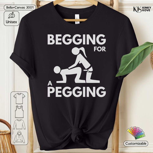 Black t-shirt with graphic design and text 'Begging for a Pegging' on a hanger.