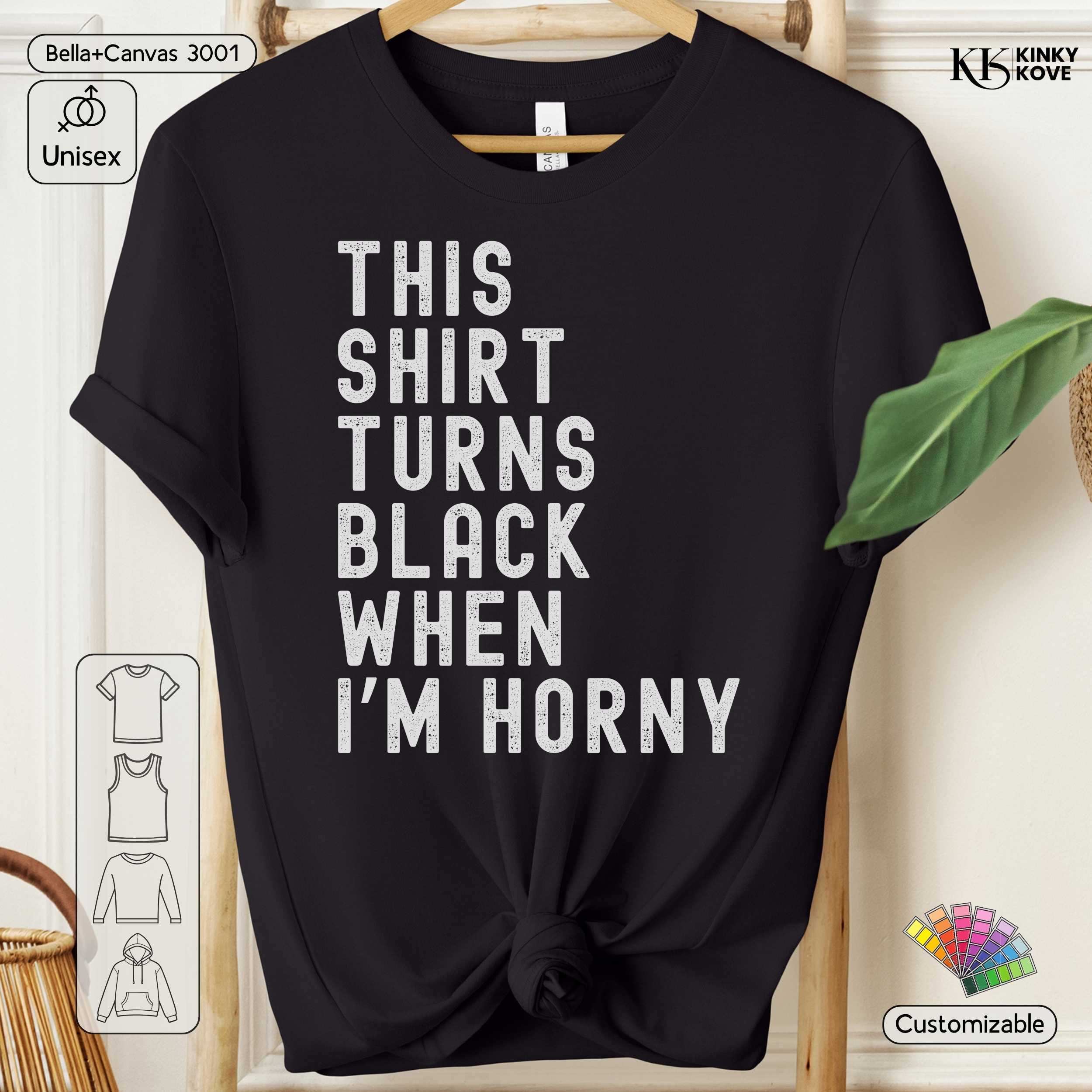 Black t-shirt with white text 'This shirt turns black when I'm horny' on a hanger.