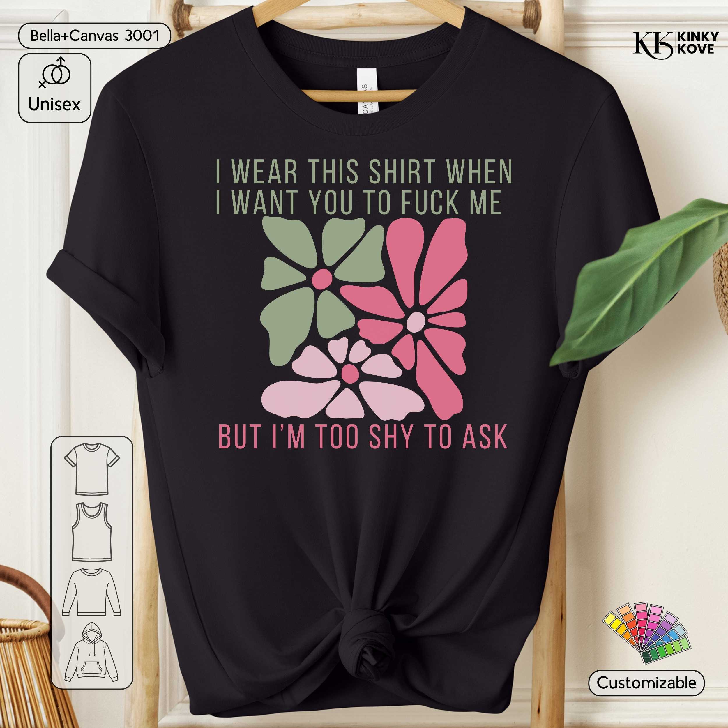 Black t-shirt with floral design and text on a hanger