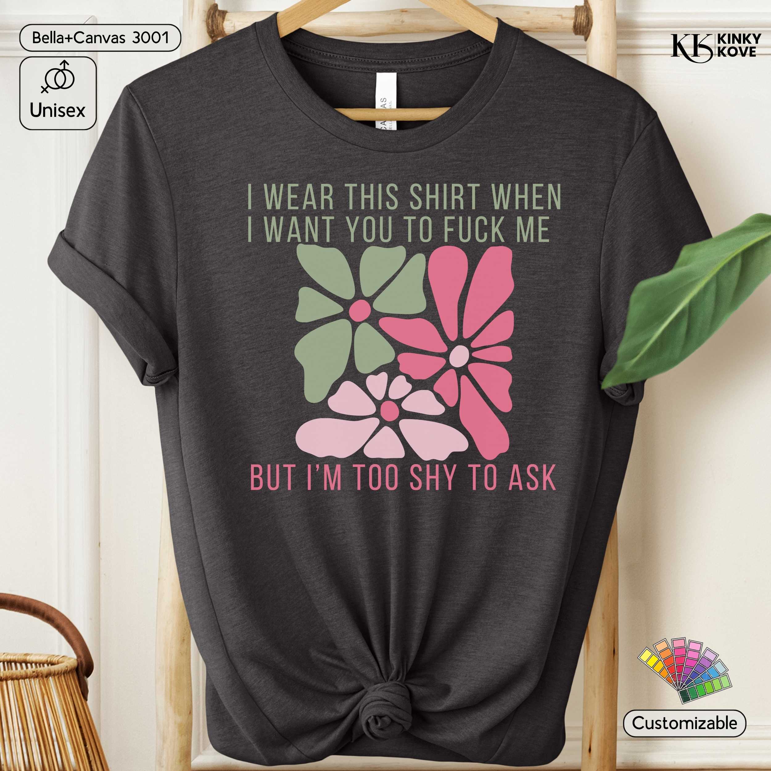 Black t-shirt with floral design and text on a hanger