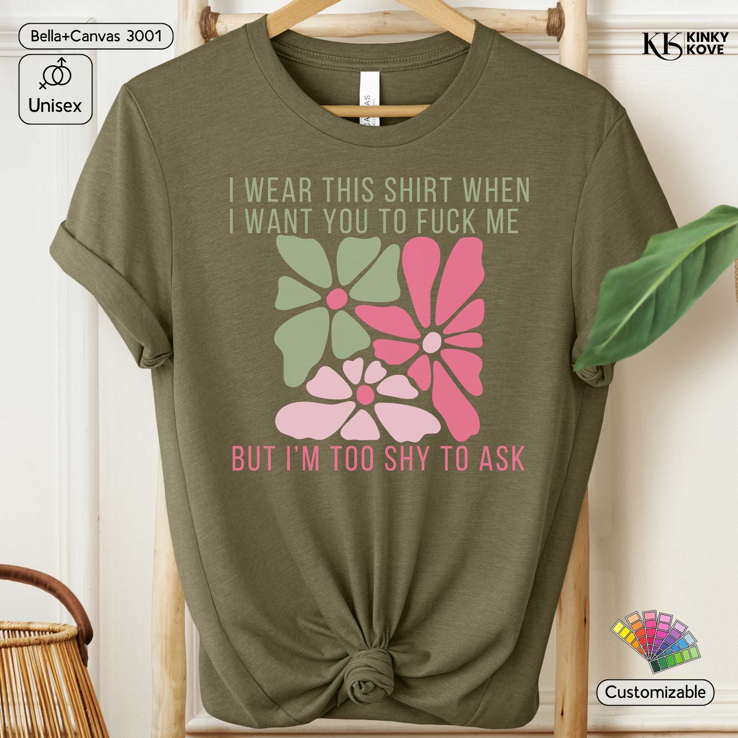 Green t-shirt with floral design and text on a hanger