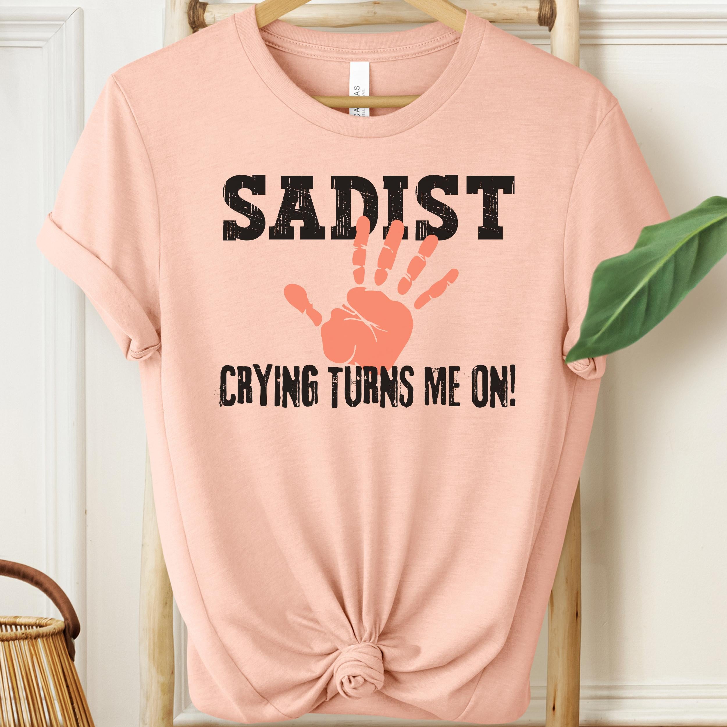 Peach colour unisex tee with sadist graphic and orange handprint logo