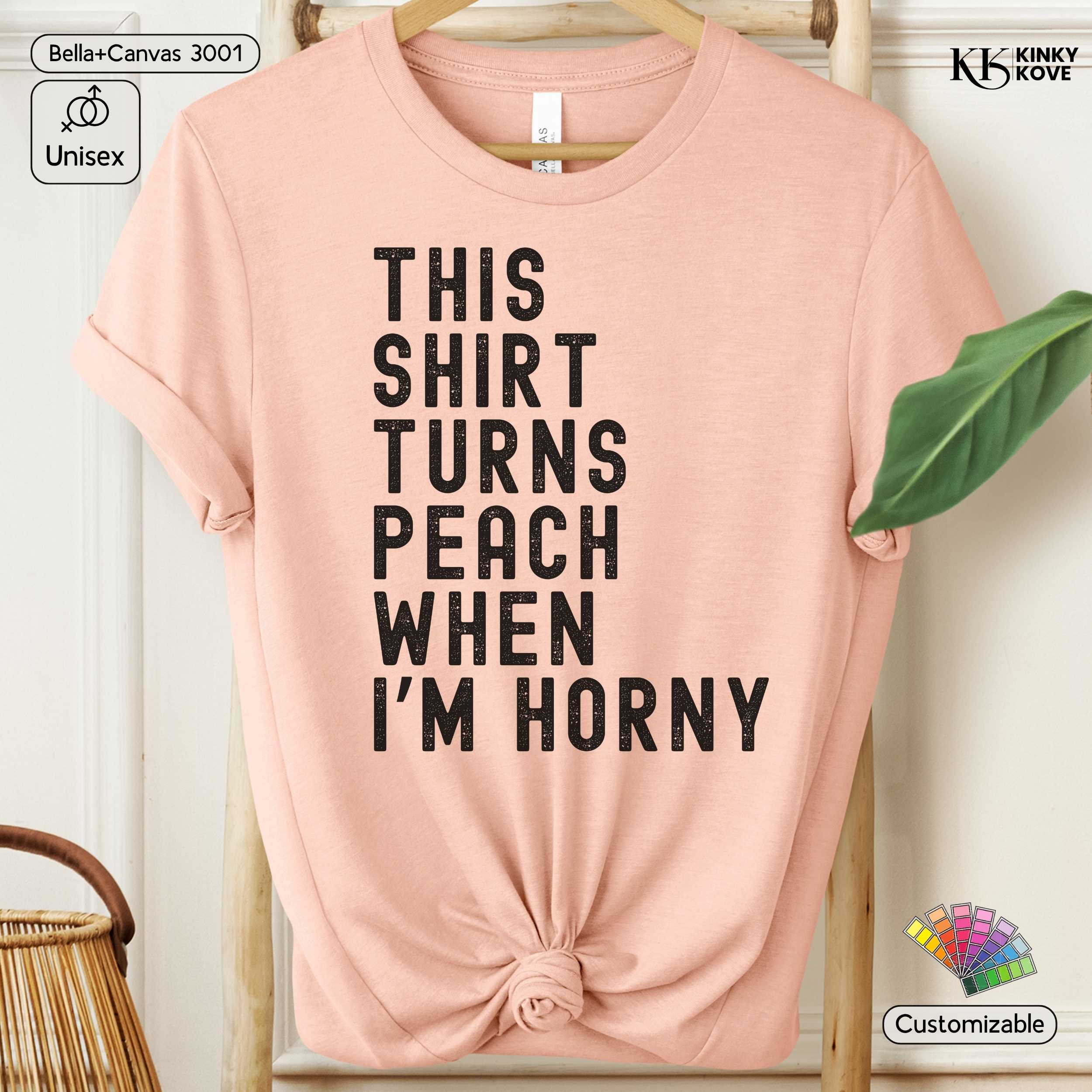 Pink t-shirt with humorous text on a hanger against a white background