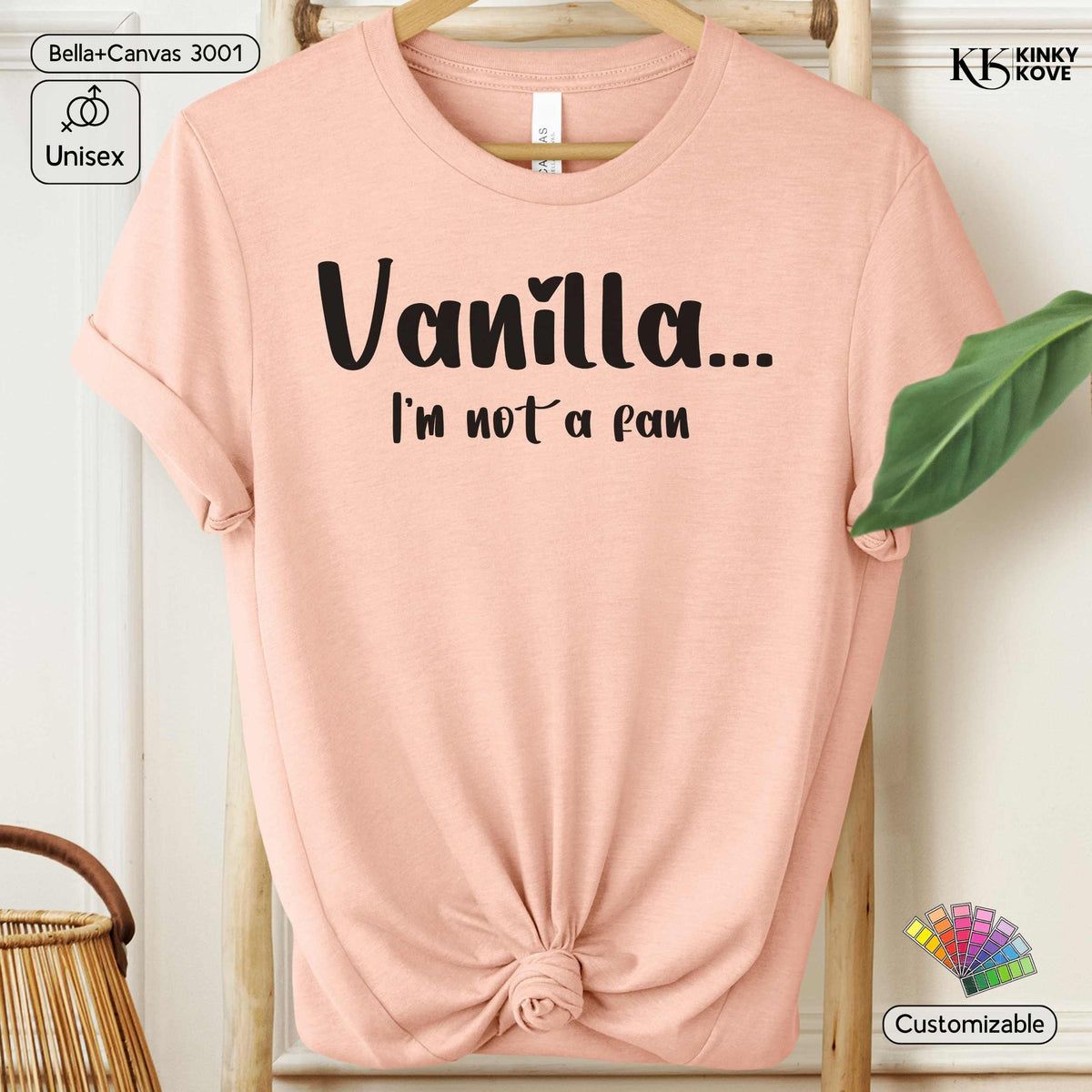 A light peach-pink short-sleeve t-shirt with rolled sleeves, featuring the black text 'Vanilla.