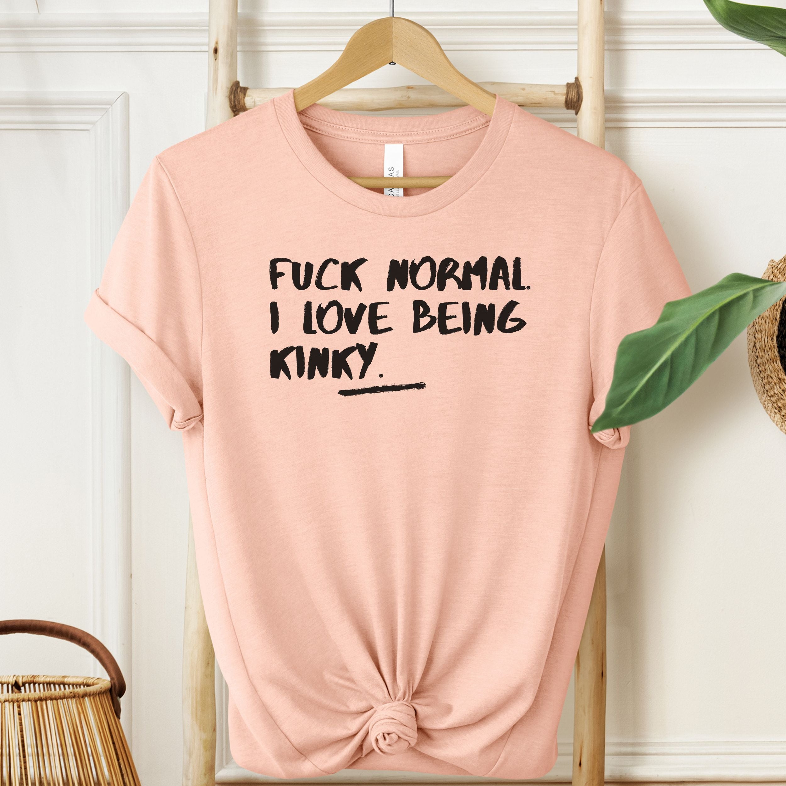 Heather Peach T-shirt with black bold kinky quote print.