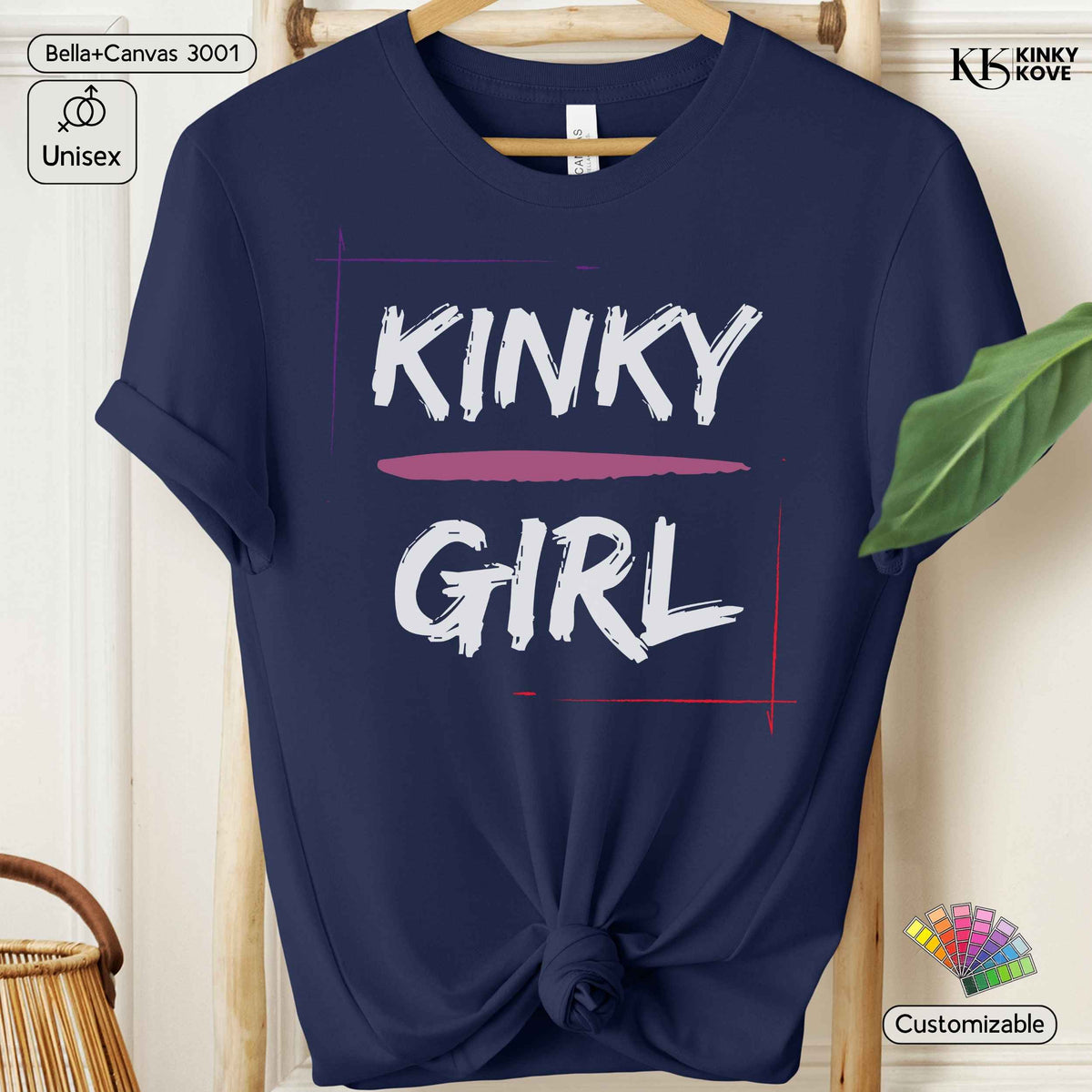 A navy blue short-sleeve t-shirt on a wooden hanger, styled with a knot at the bottom hem. The shirt features a graphic print that reads 'KINKY GIRL' in white brush-style lettering, with 'KINKY' above a pink horizontal line and 'GIRL' below, framed by thin red and purple lines.