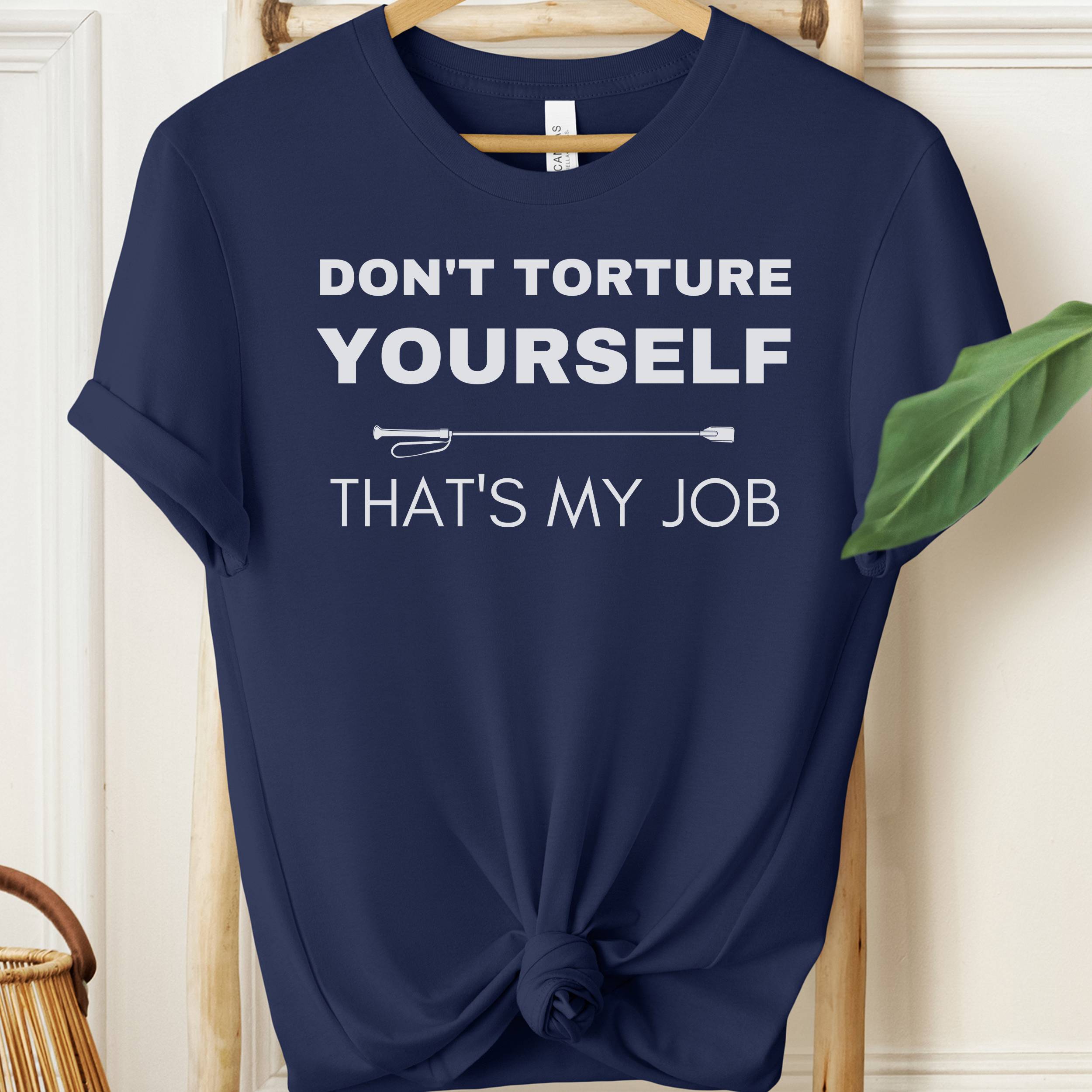 Navy blue t-shirt with white text on a wooden hanger against a light background