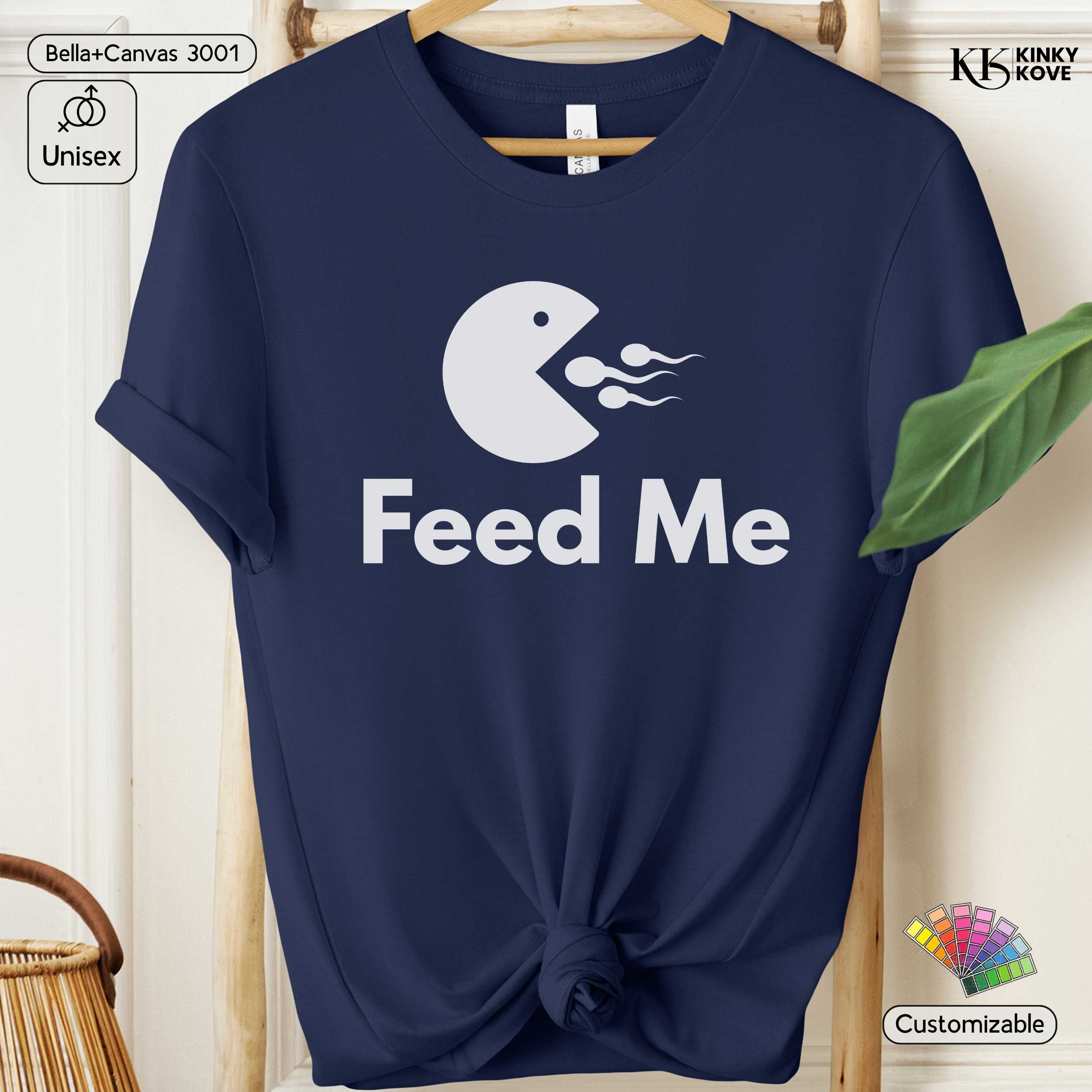 Navy blue t-shirt with 'Feed Me' graphic design on a hanger.