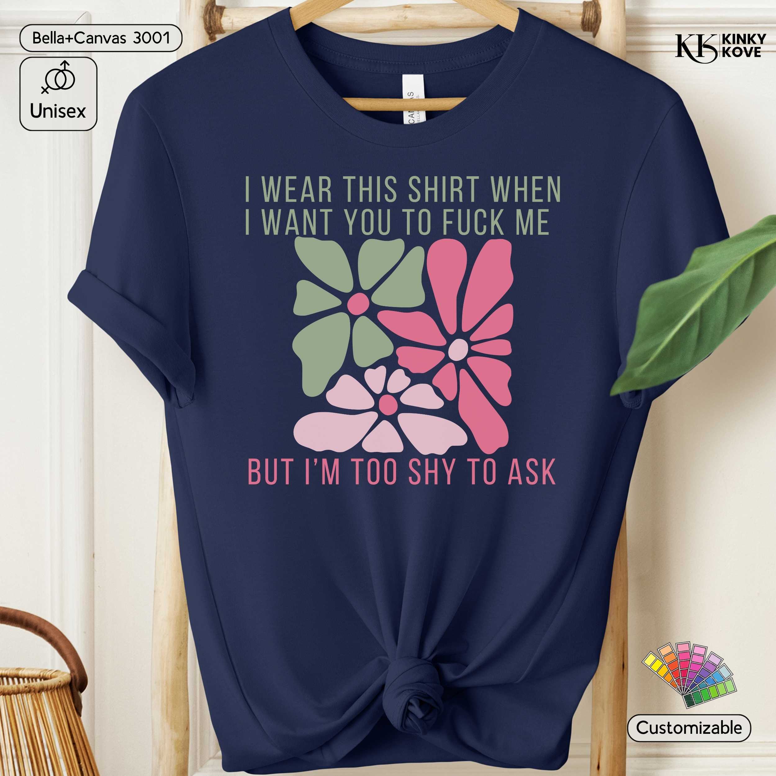 Navy blue t-shirt with floral design and text on a hanger