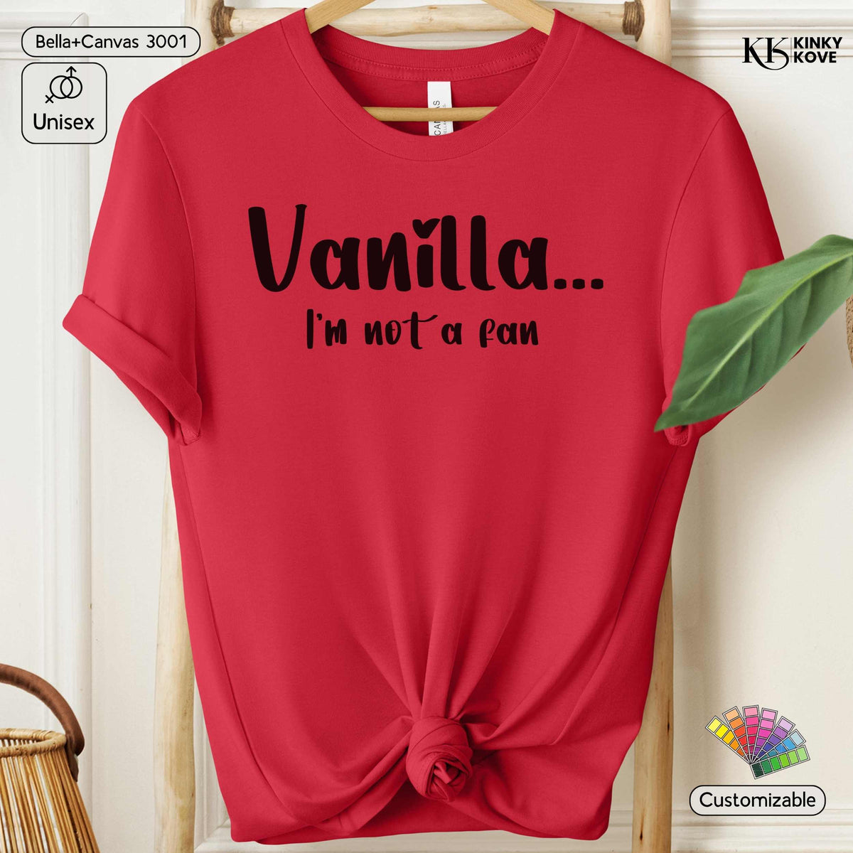 A red short-sleeve t-shirt hanging on a wooden hanger, styled with a knot at the bottom hem. The shirt features the black printed text 'Vanilla.
