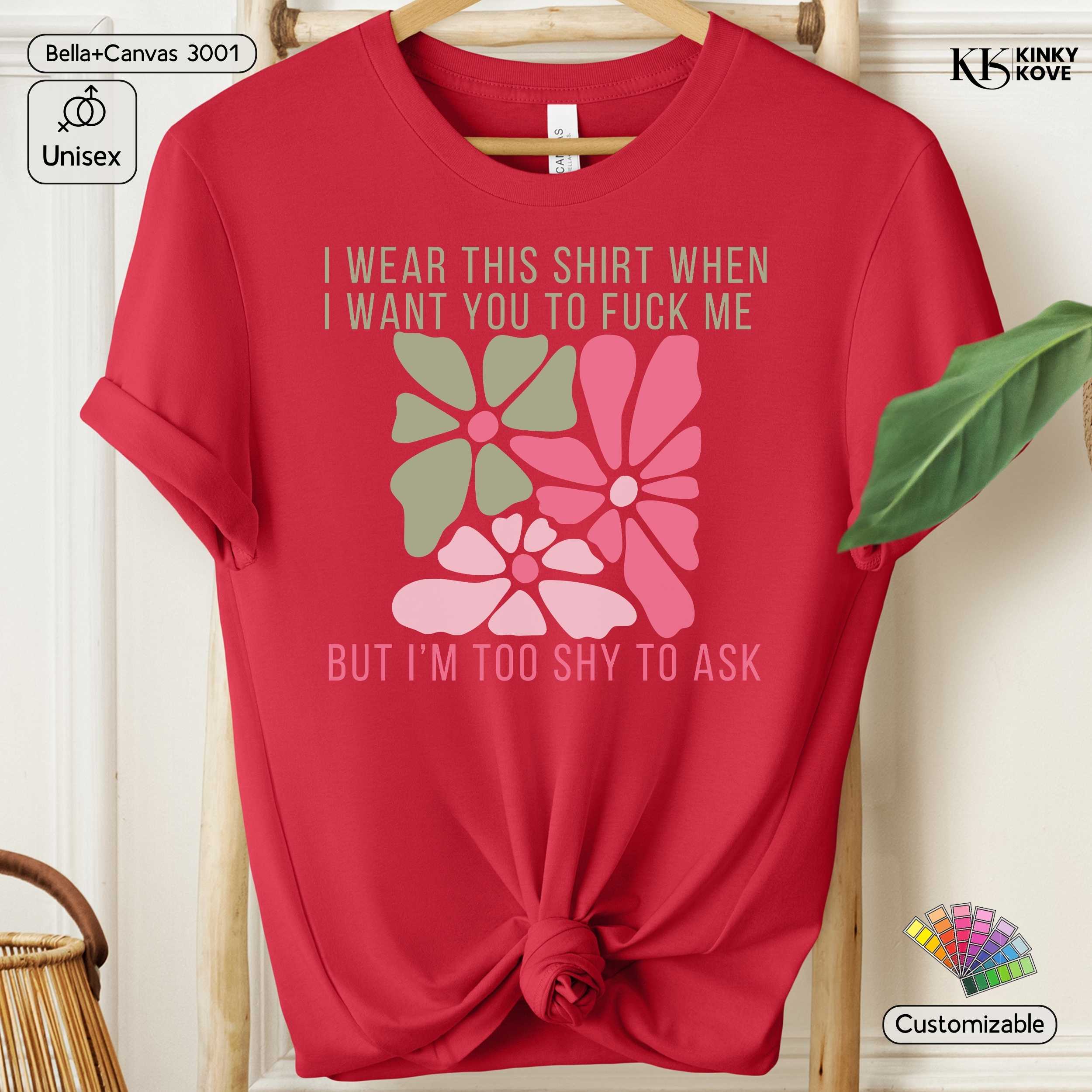 Red t-shirt with floral design and text on a hanger