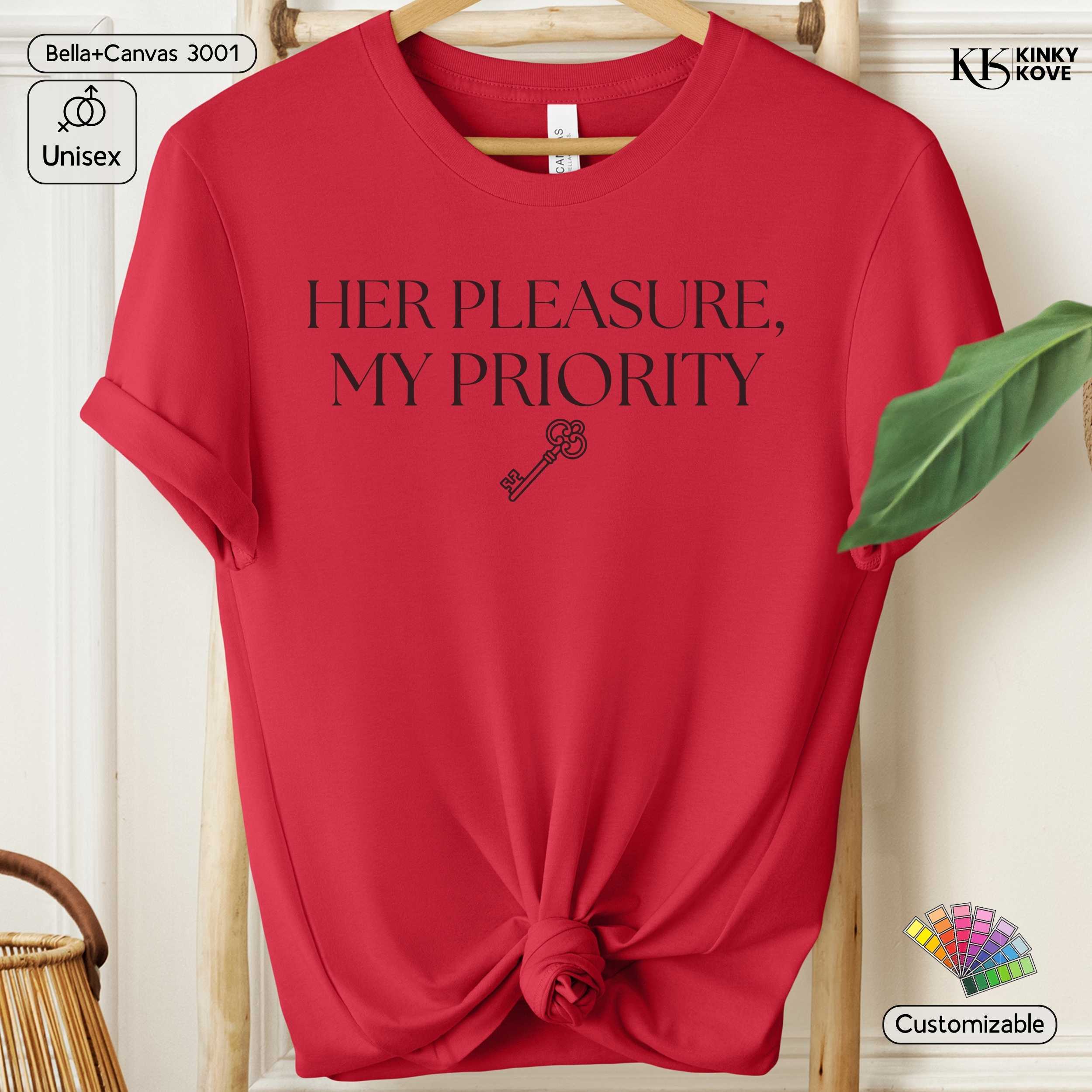 Red t-shirt with 'HER PLEASURE, MY PRIORITY' text and key graphic on a hanger.