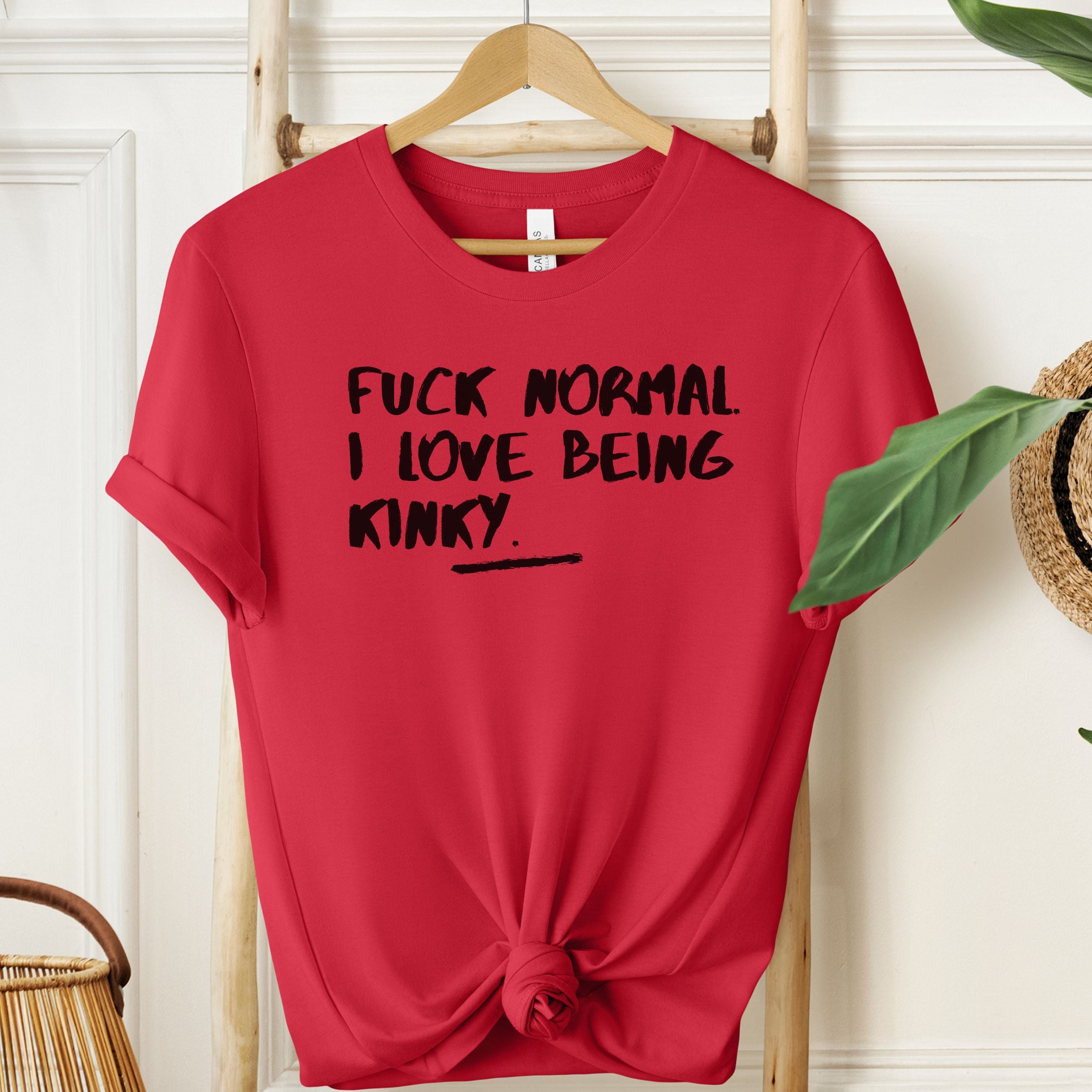 Red T-shirt with black kinky statement slogan.