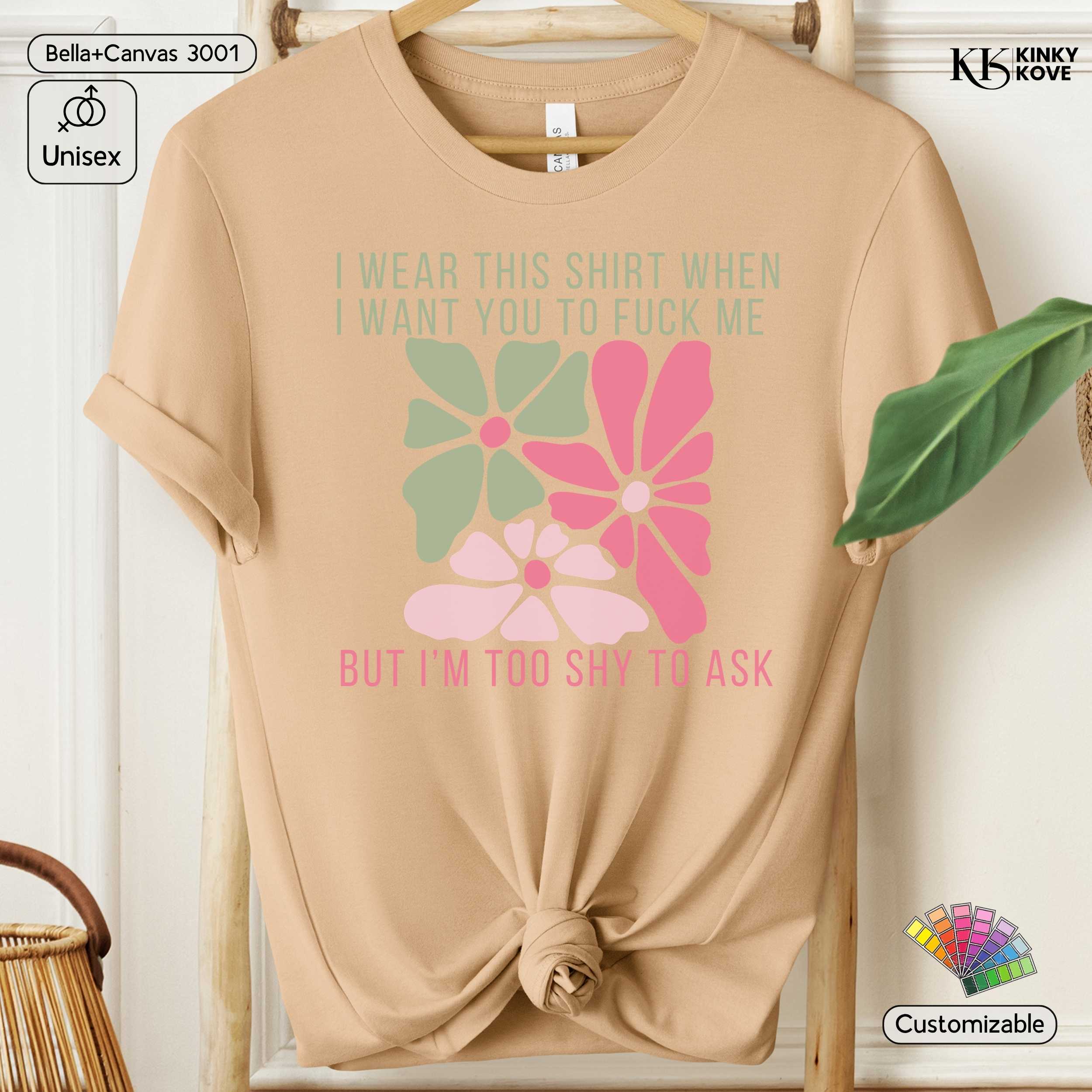 Beige t-shirt with floral design and text on a hanger