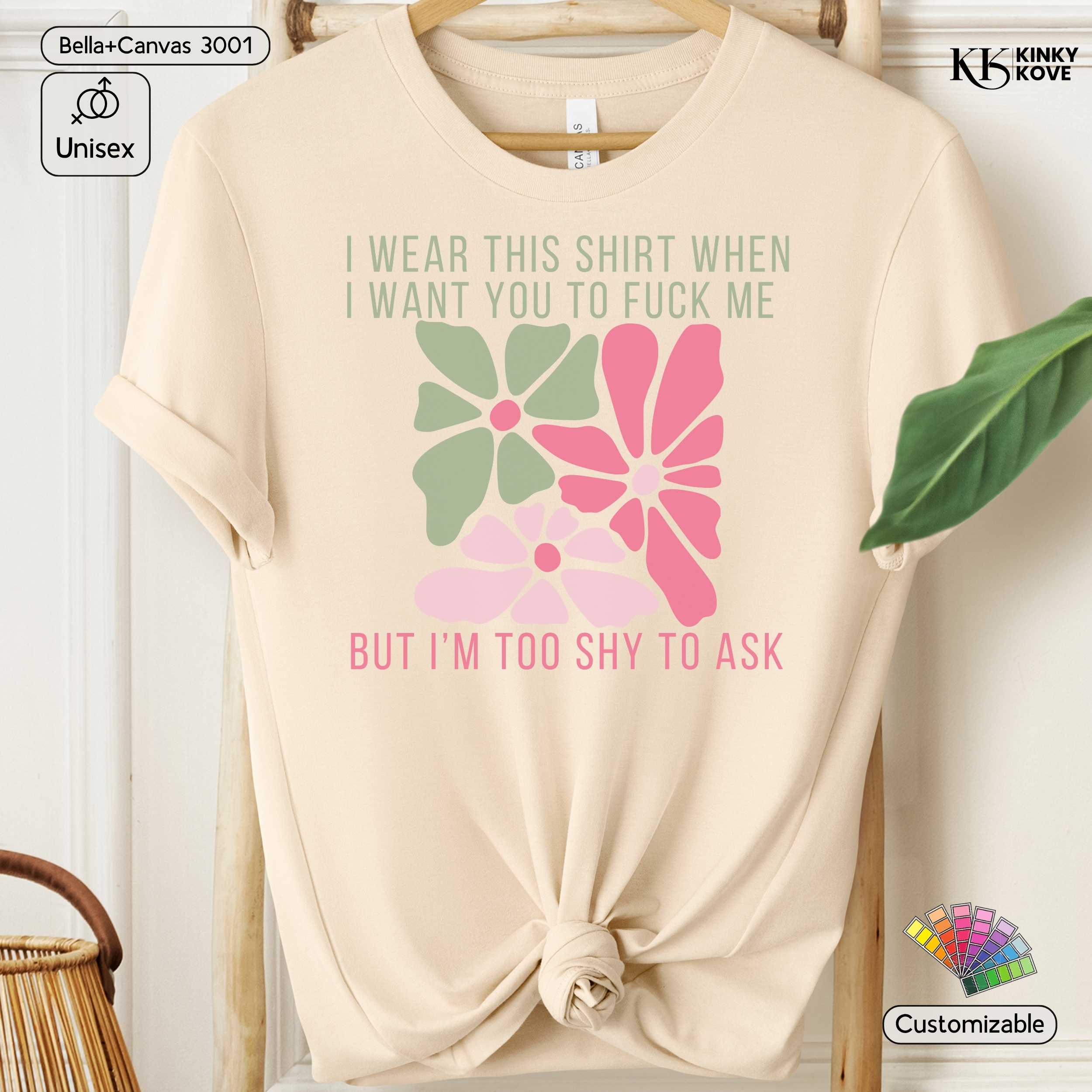 Beige t-shirt with floral design and text on a hanger