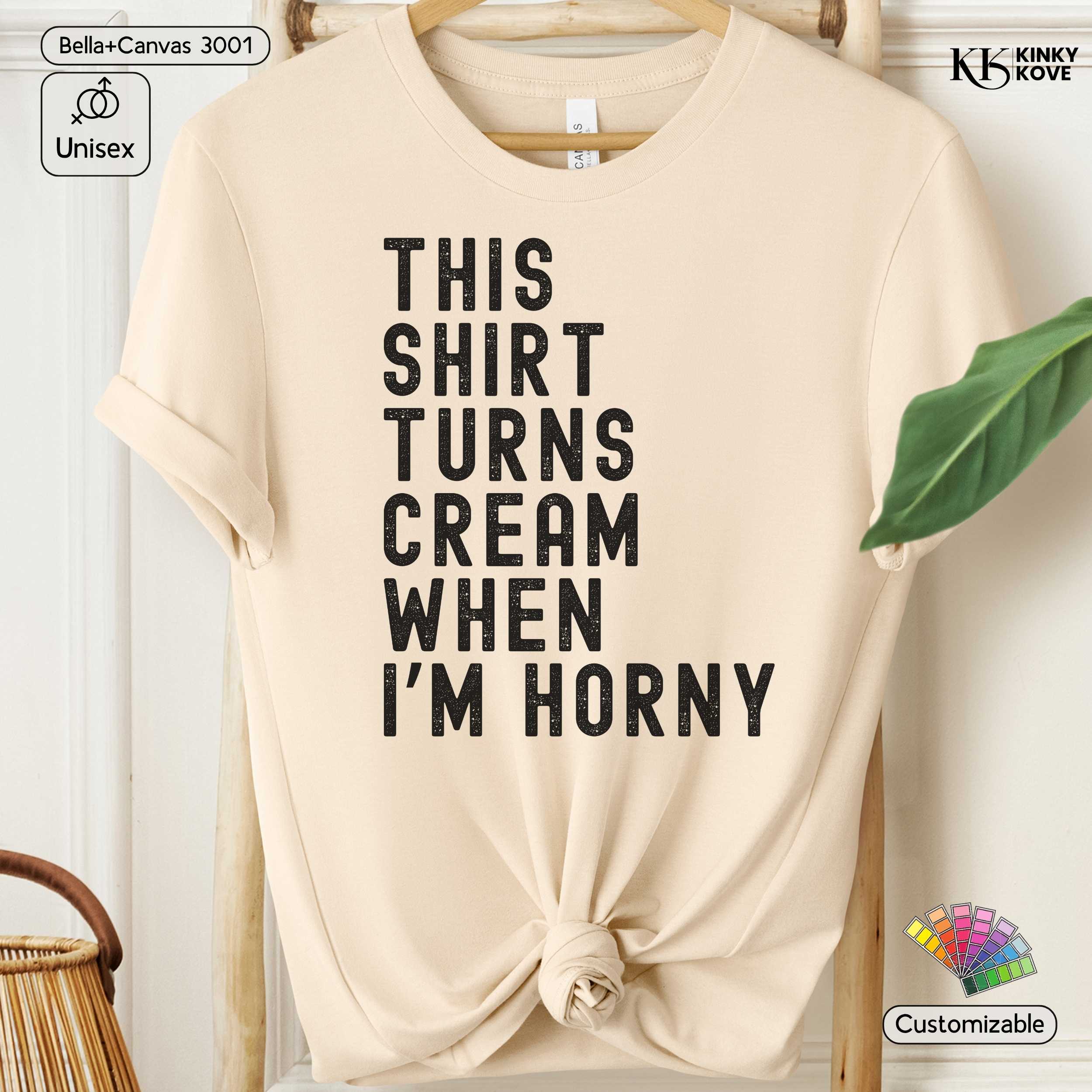 Beige t-shirt with humorous text on a hanger against a white background
