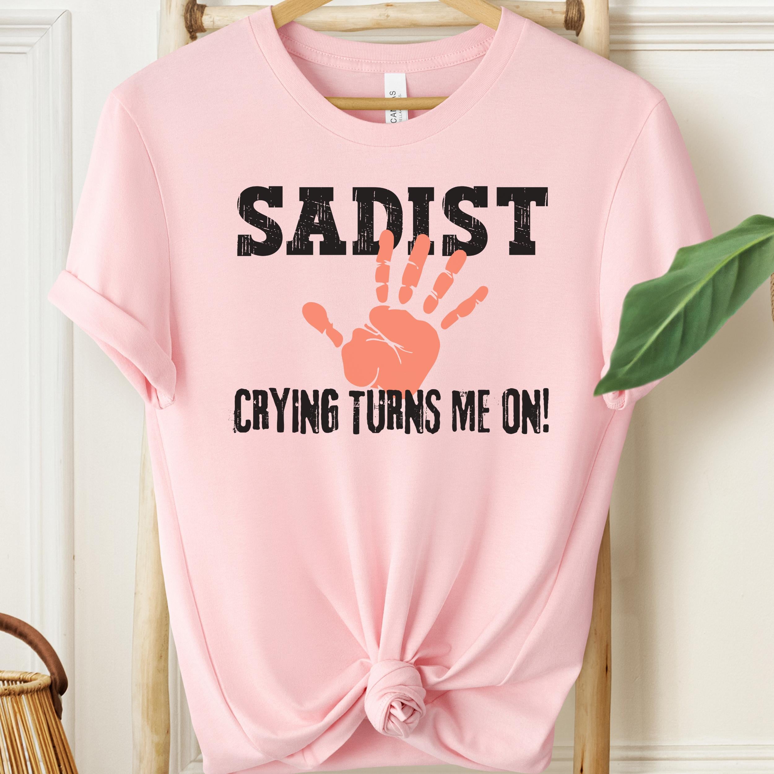 Soft pink kinky humour shirt with sadist text and stylised hand graphic
