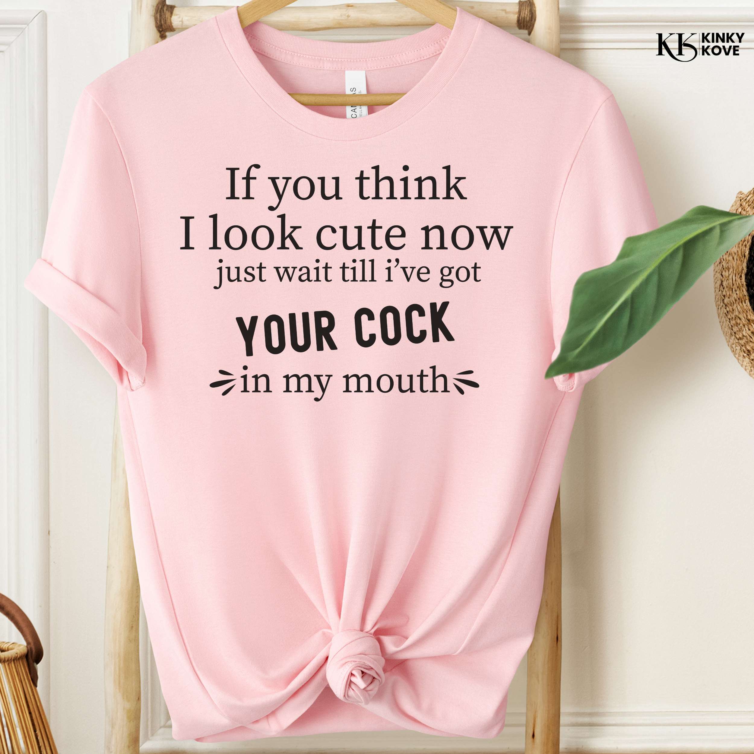 Pink t-shirt with a humorous graphic and text on a white background