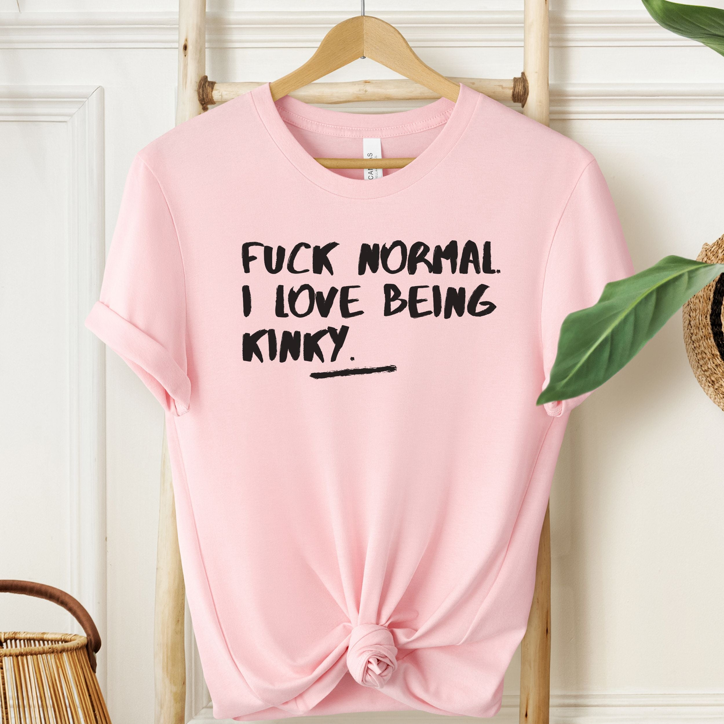 White T-shirt with black “Fuck Normal I Love Being Kinky” text graphic.
