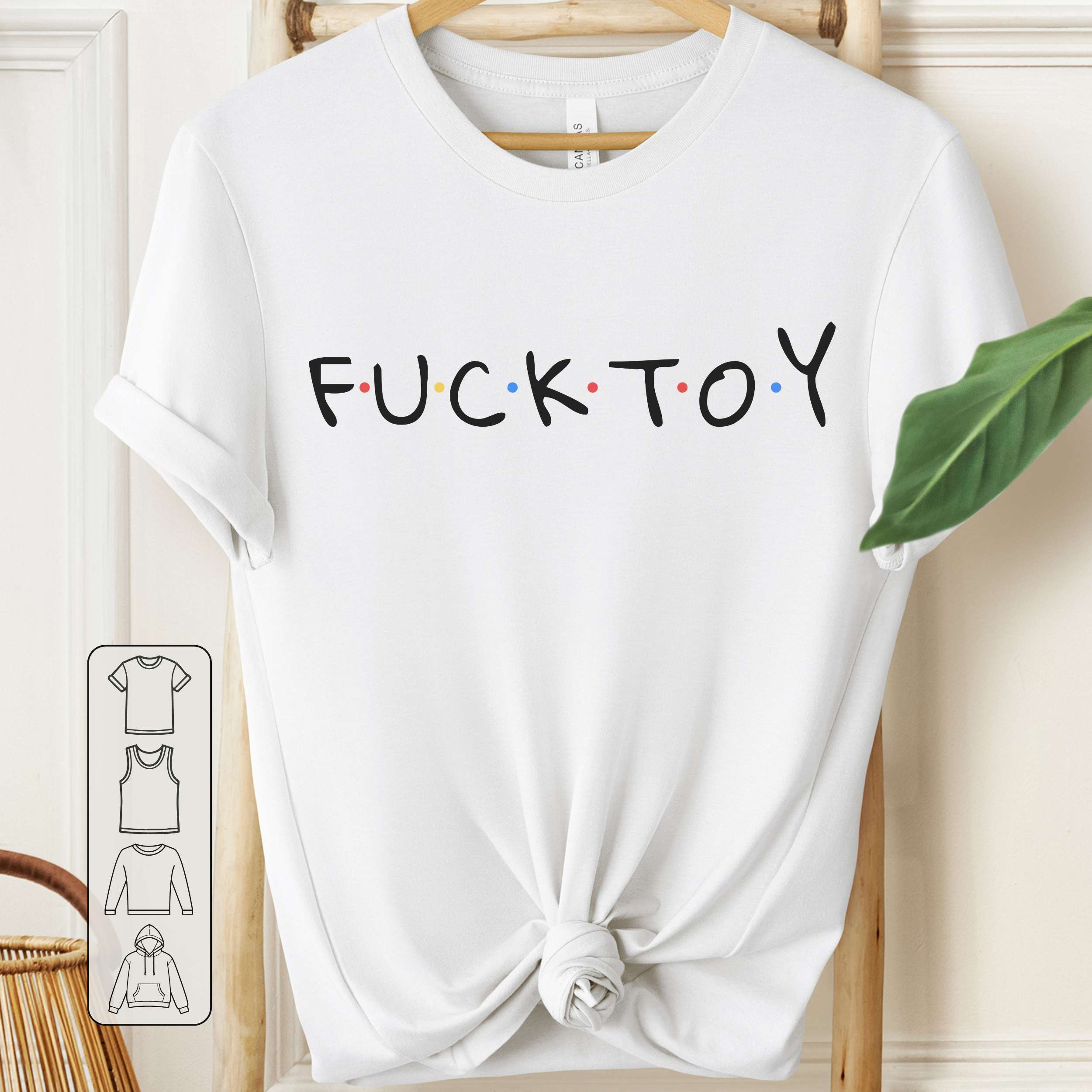White t-shirt with 'FUCK TOY' text on a wooden hanger.