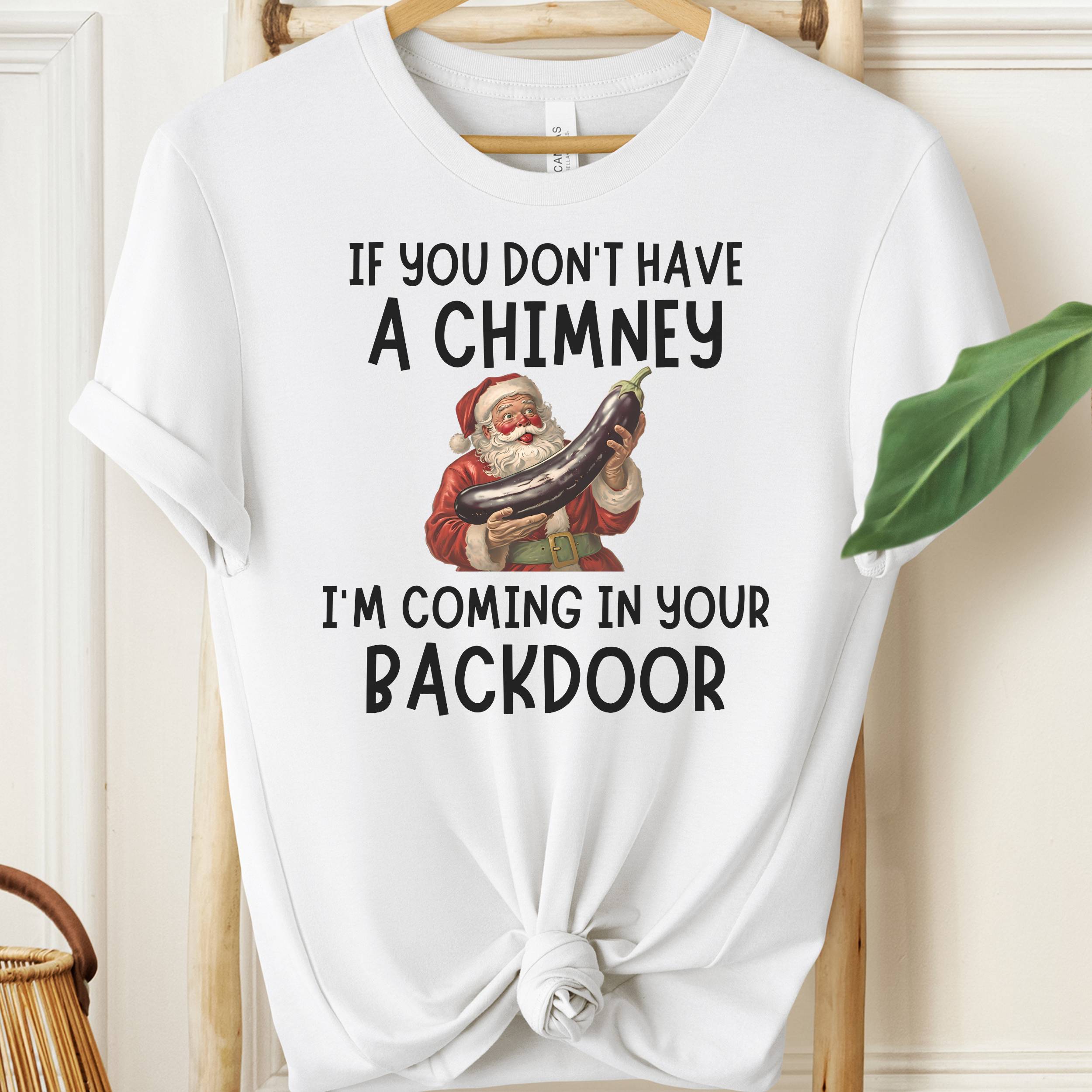 White t-shirt with Santa Claus graphic and humorous text on a hanger.