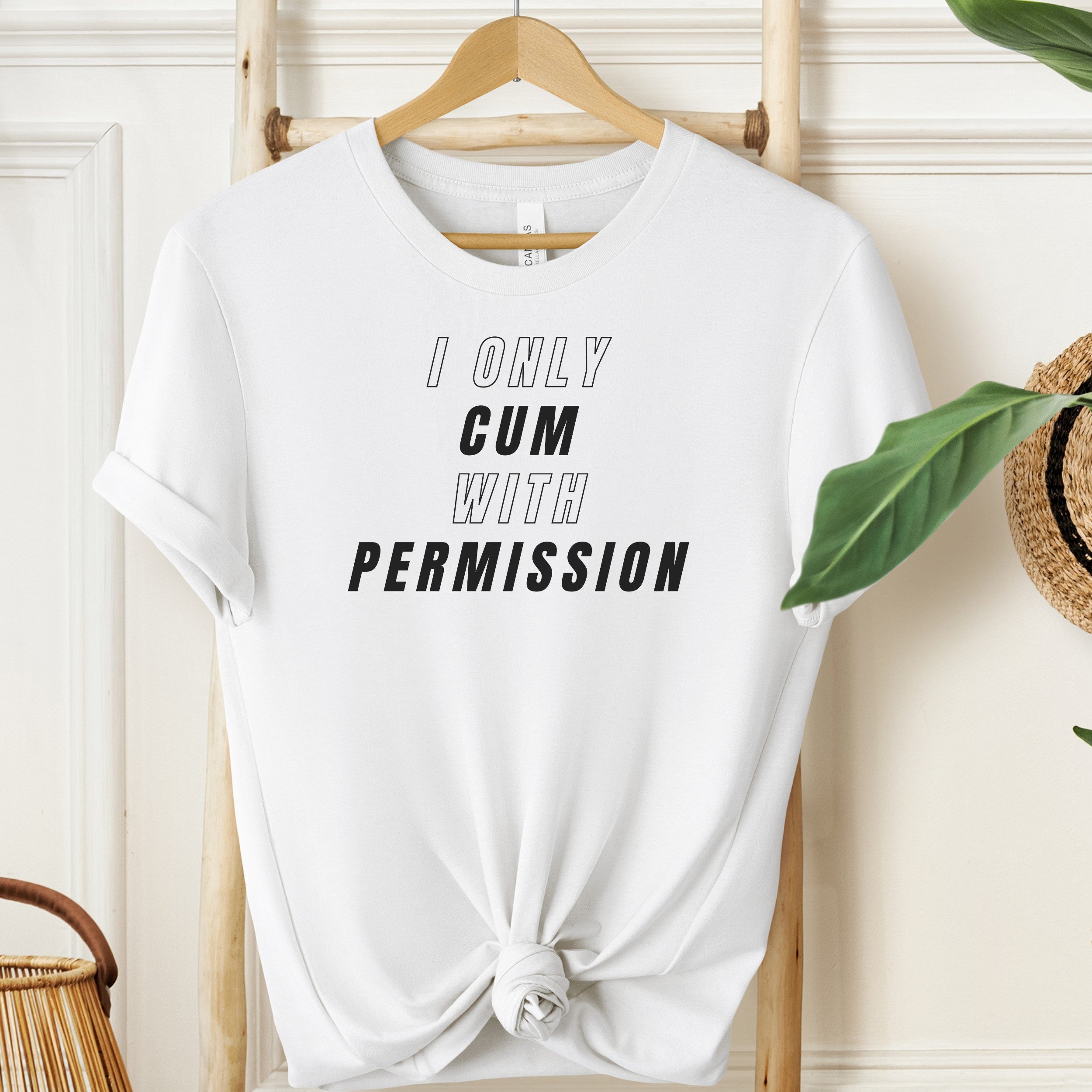 White t-shirt with text 'I ONLY CUM WITH PERMISSION' on a hanger.