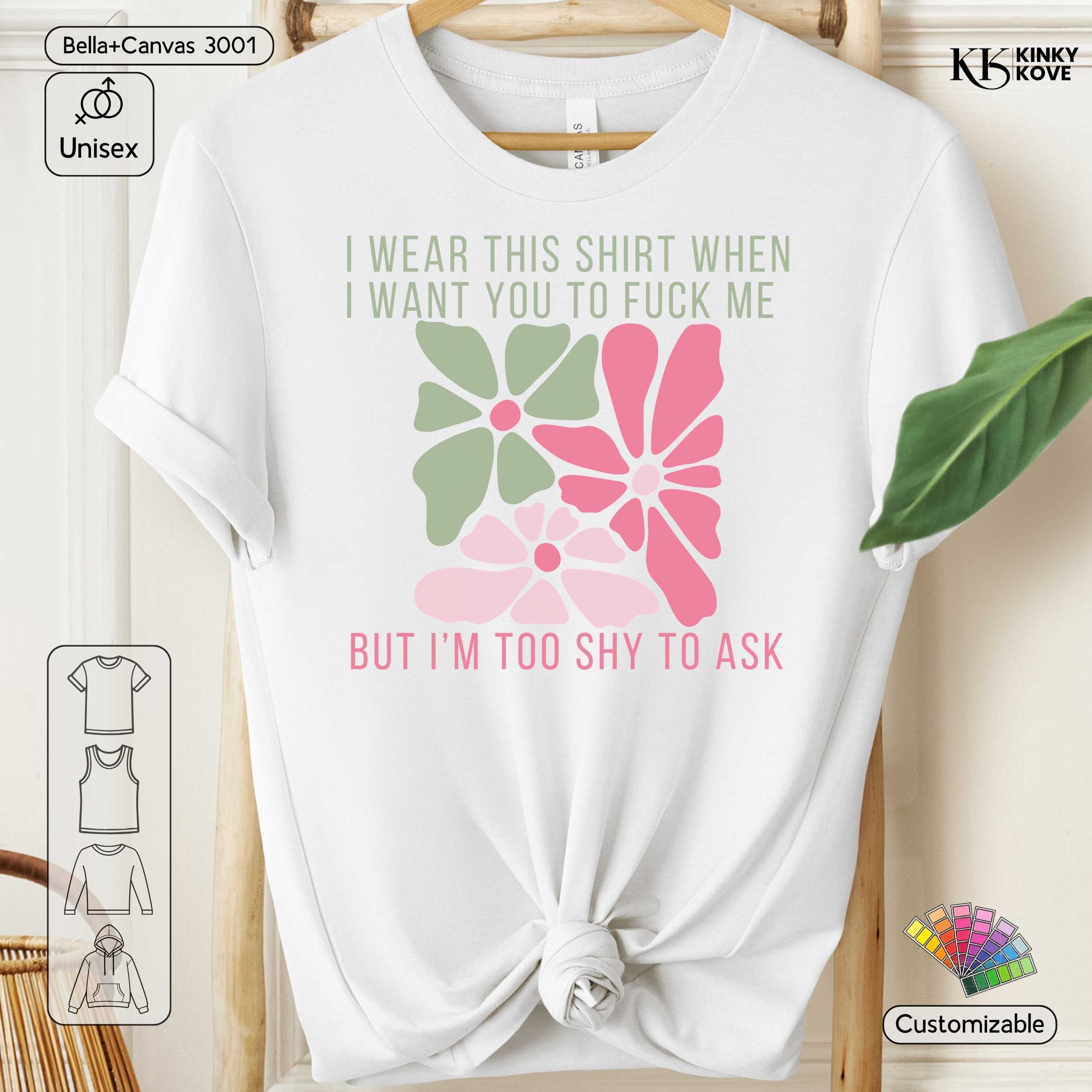White t-shirt with floral design and text on a wooden hanger