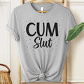 Gray t-shirt with 'Cum Slut' text on a hanger