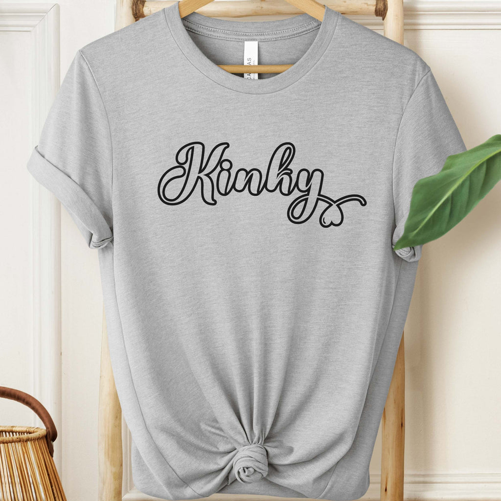 Gray t-shirt with 'Kinky' text on a hanger against a neutral background