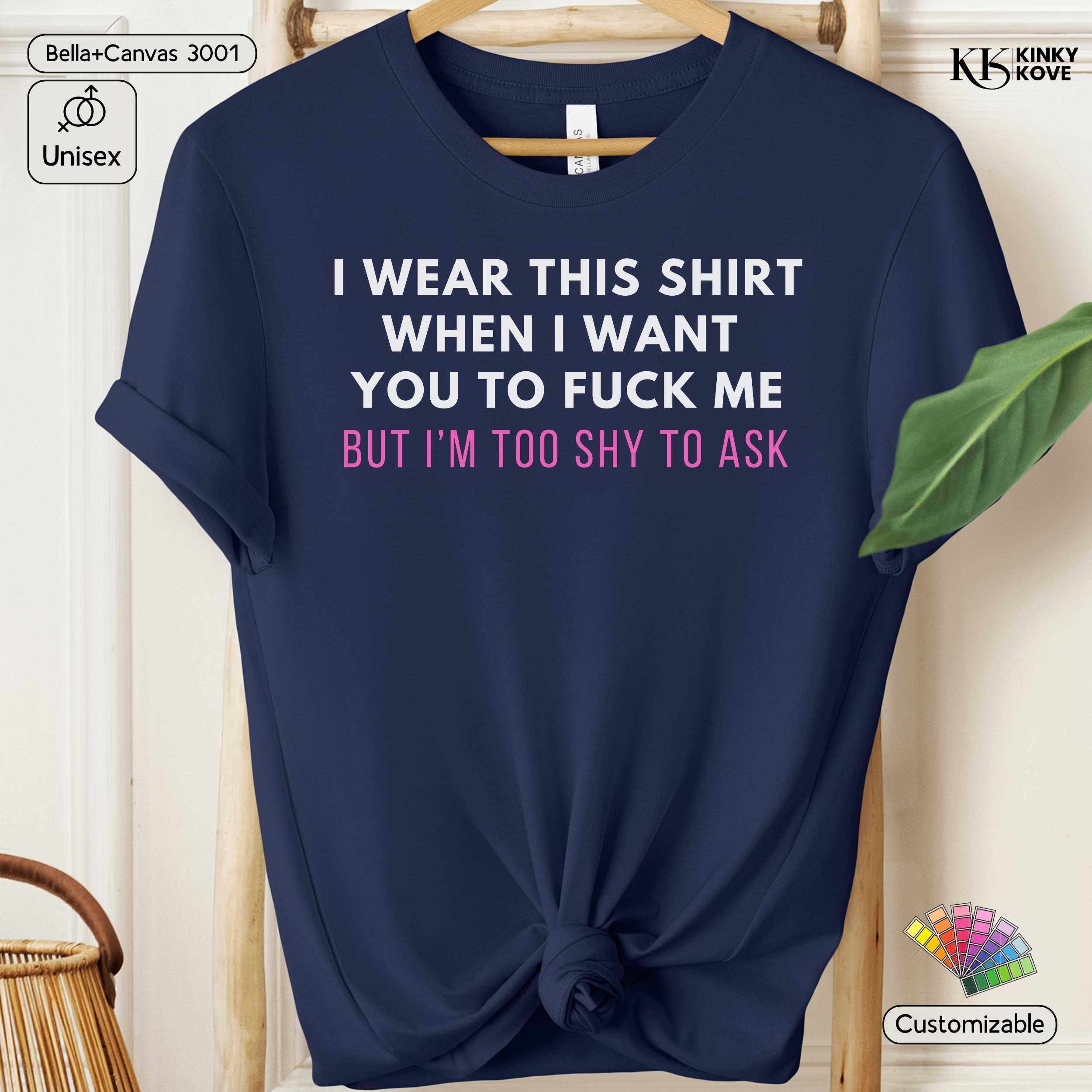 Navy blue t-shirt with text on a hanger against a neutral background