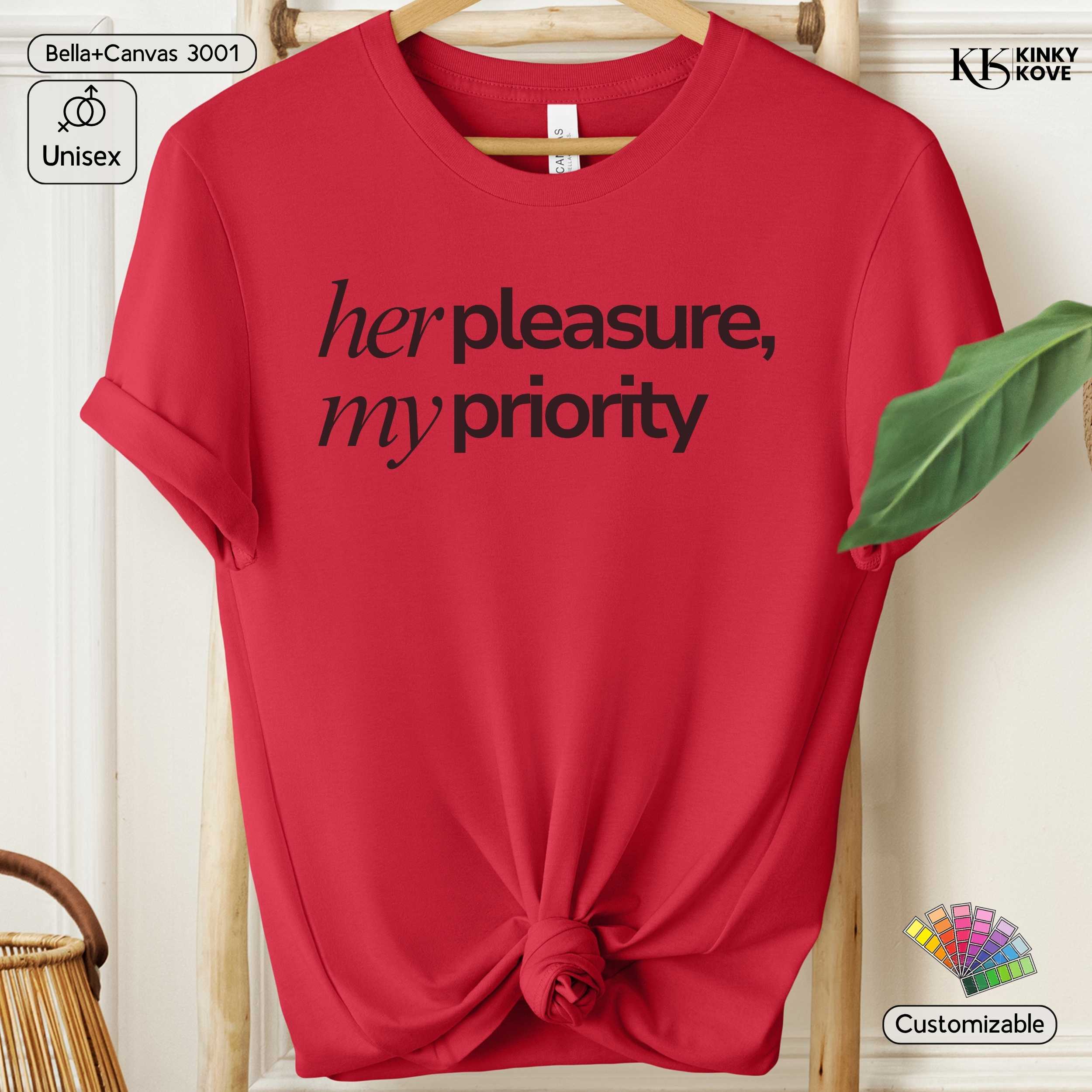 Red t-shirt with 'her pleasure, my priority' text on a hanger against a white background.