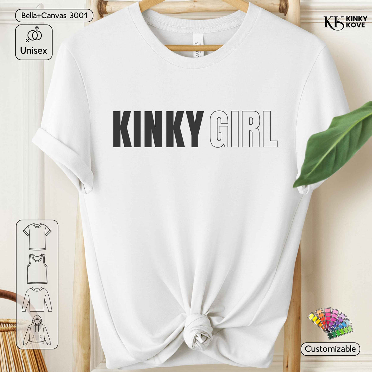 White short-sleeve t-shirt with 'KINKY GIRL' printed across the chest, styled tied at the hem and hanging on a wooden hanger against a light wood background.