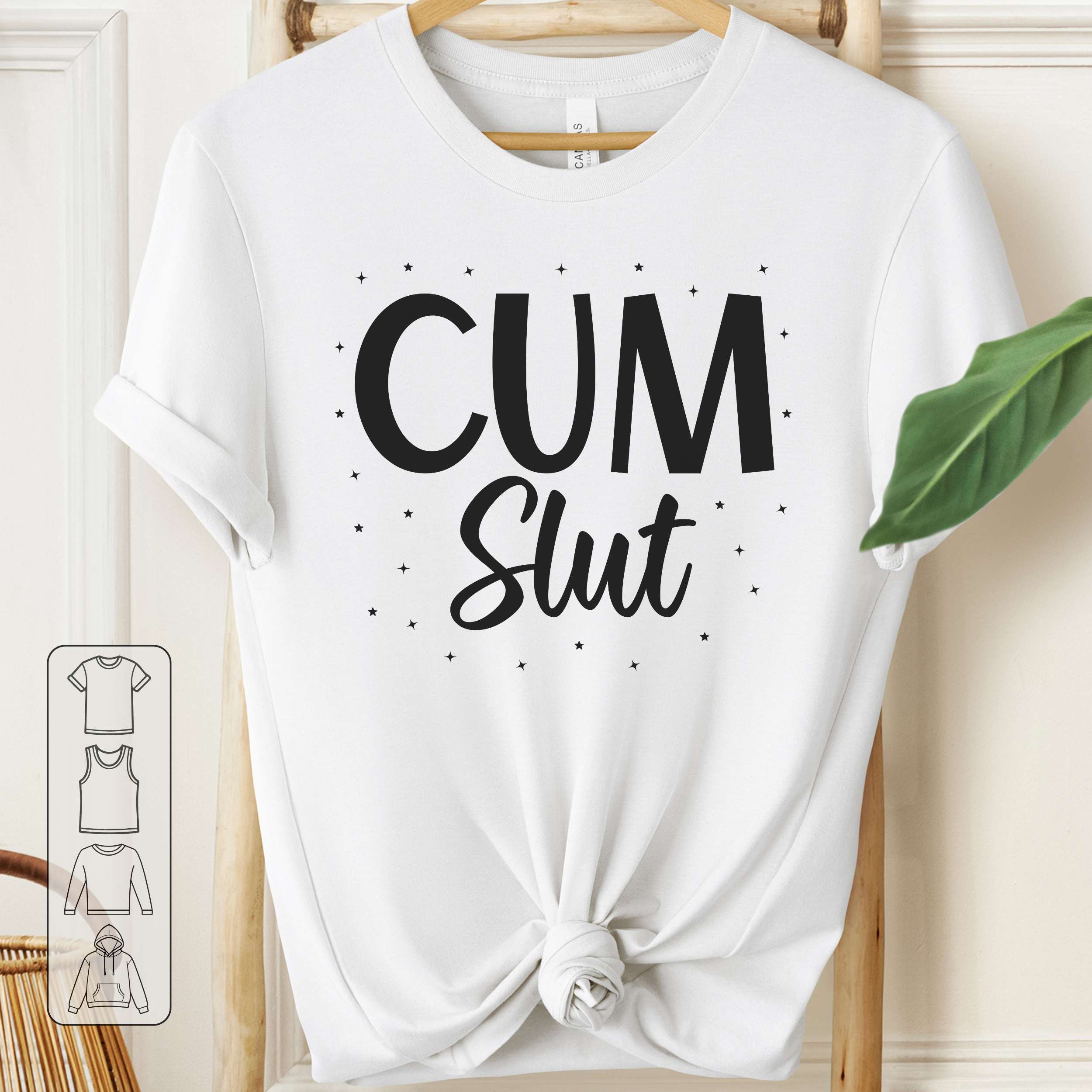 White t-shirt with 'Cum Slut' text on a wooden hanger.