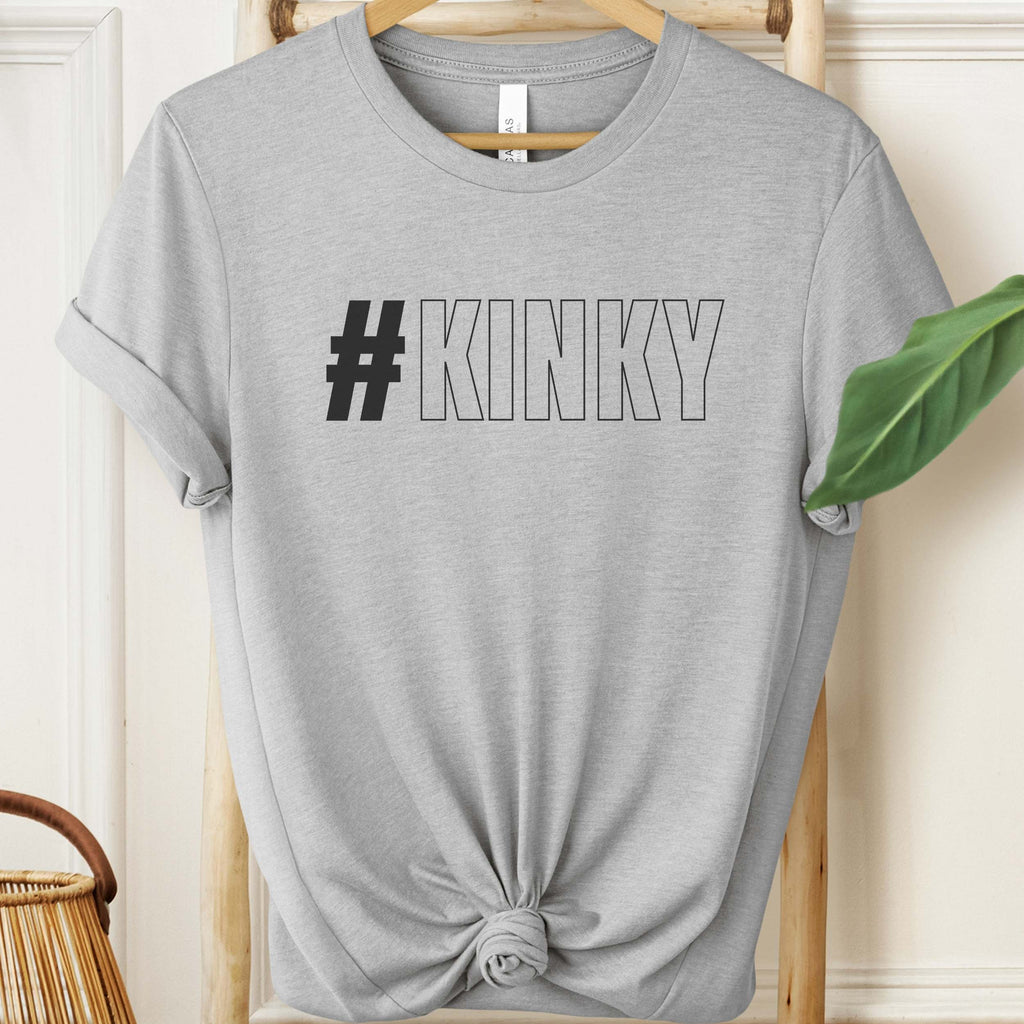 Gray t-shirt with '#KINKY' text on a hanger against a neutral background