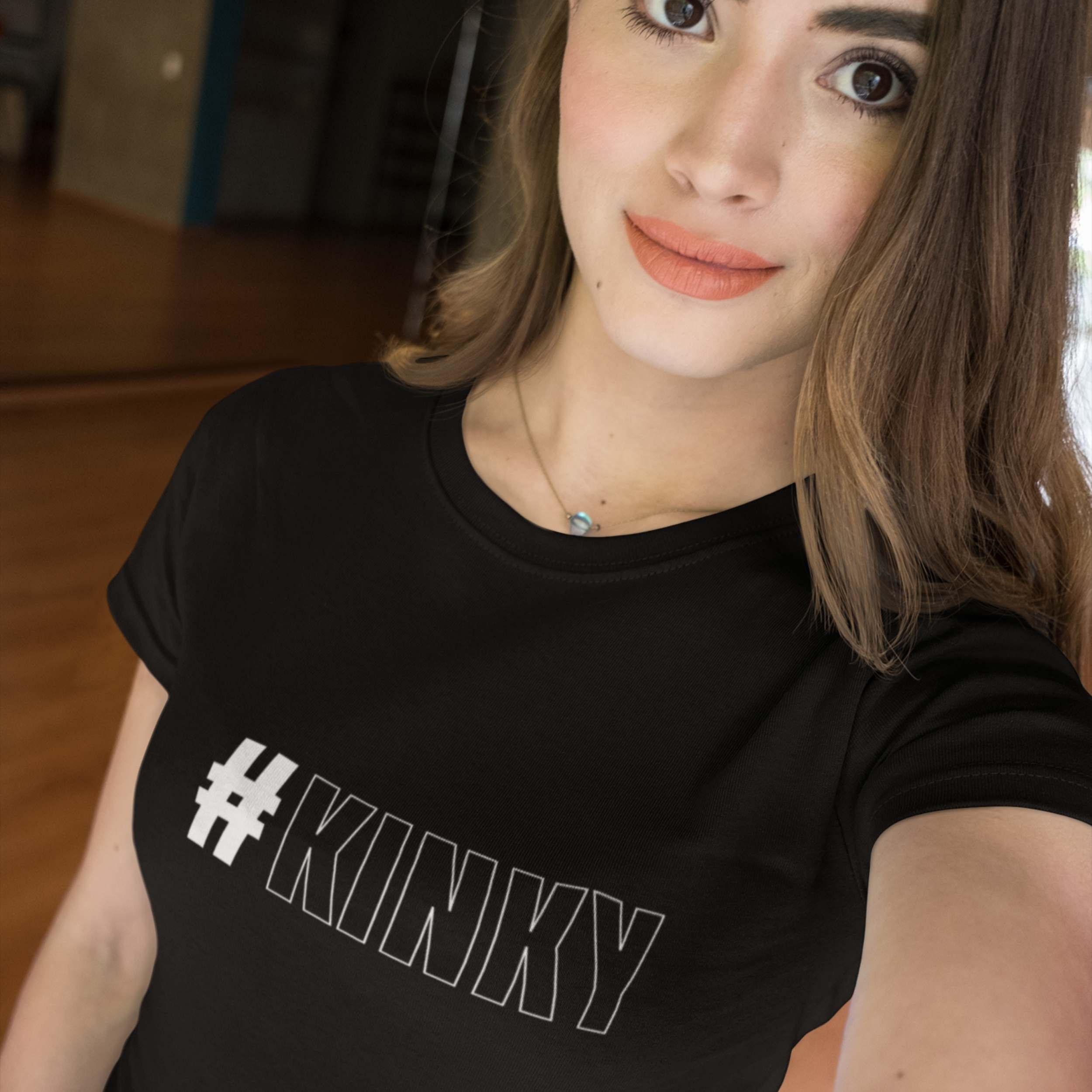 Person wearing a black t-shirt with '#KINKY' text