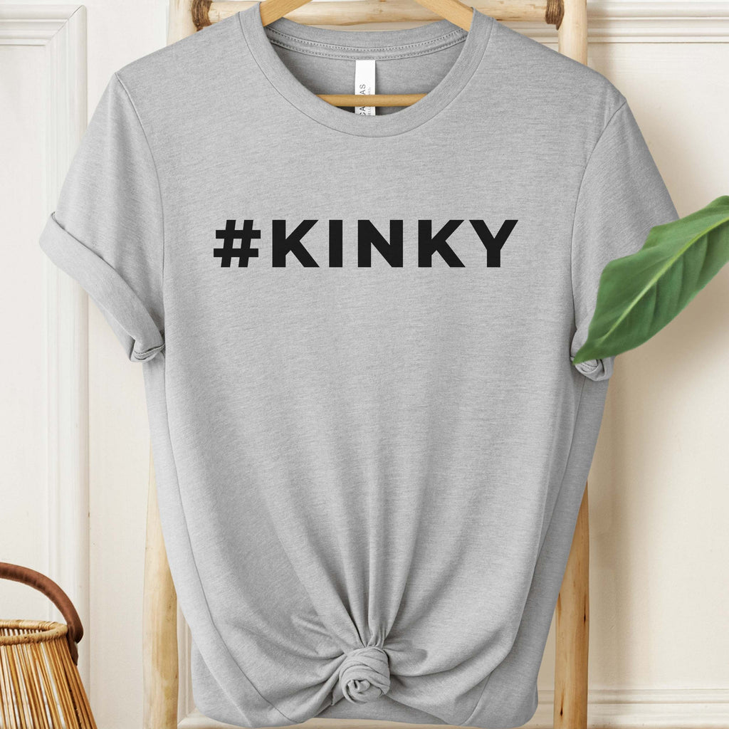 Gray t-shirt with '#KINKY' text on a hanger against a neutral background