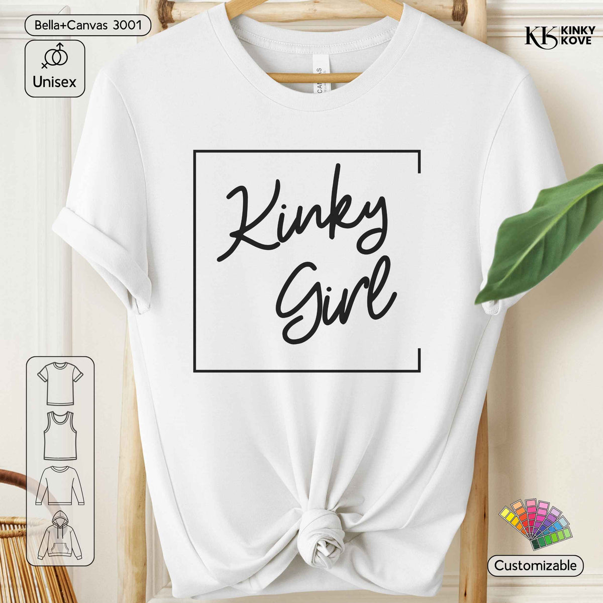 White short-sleeve t-shirt with a black graphic reading 'Kinky Girl' inside a square border, styled on a wooden hanger with a knotted hem against a light wood background.