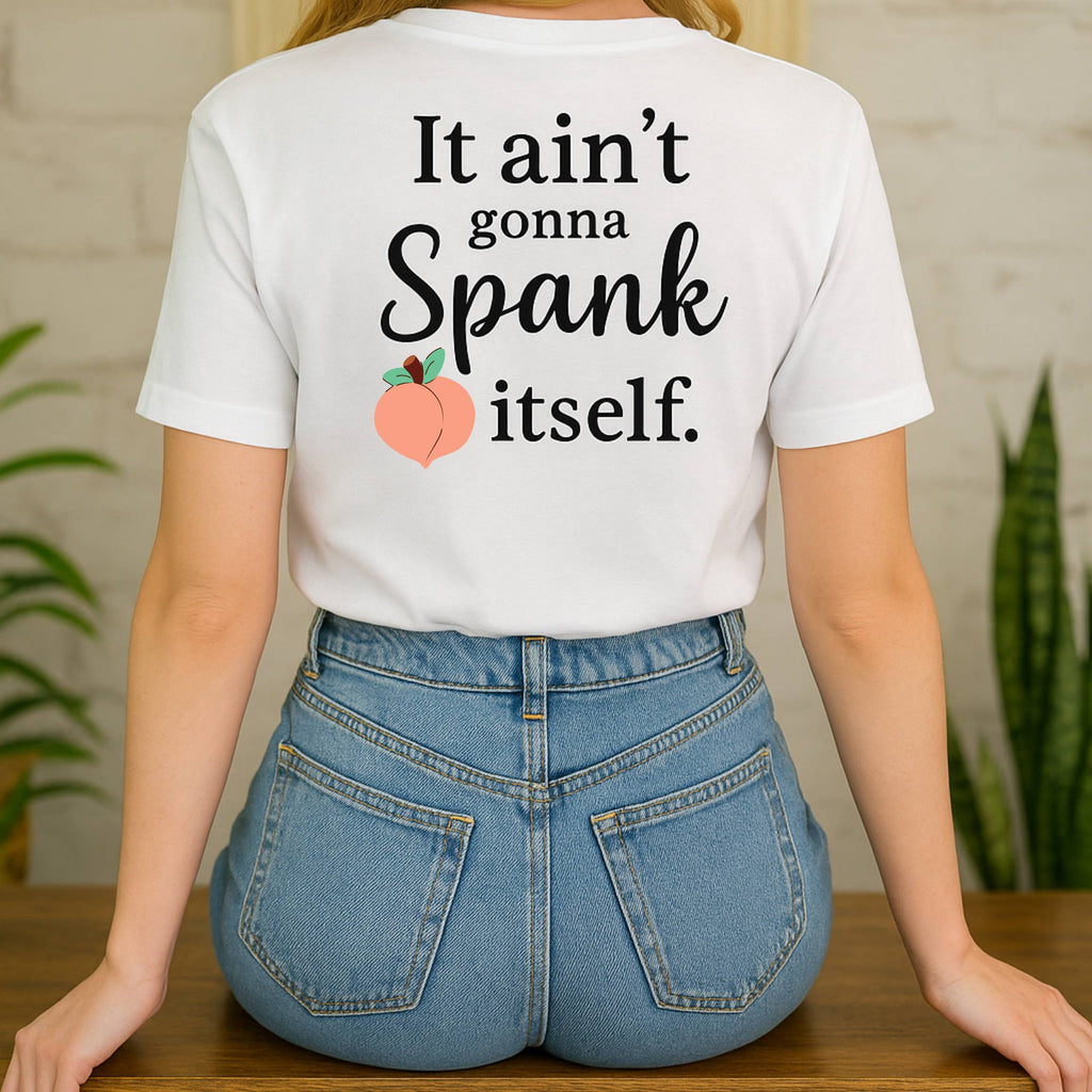 Person wearing a white t-shirt with humorous text and peach graphic, standing in a casual setting.