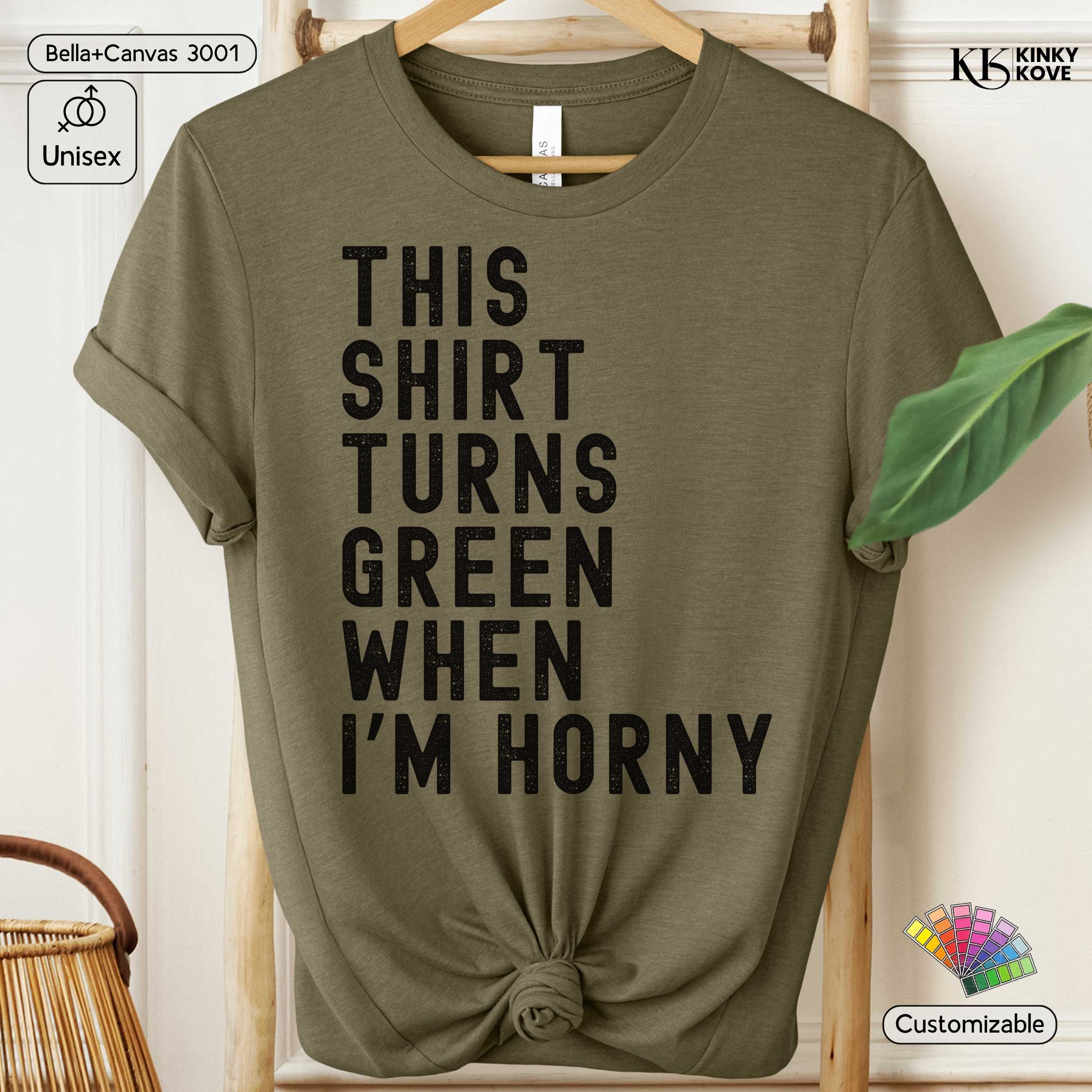 Green t-shirt with text 'This shirt turns green when I'm horny' on a hanger.