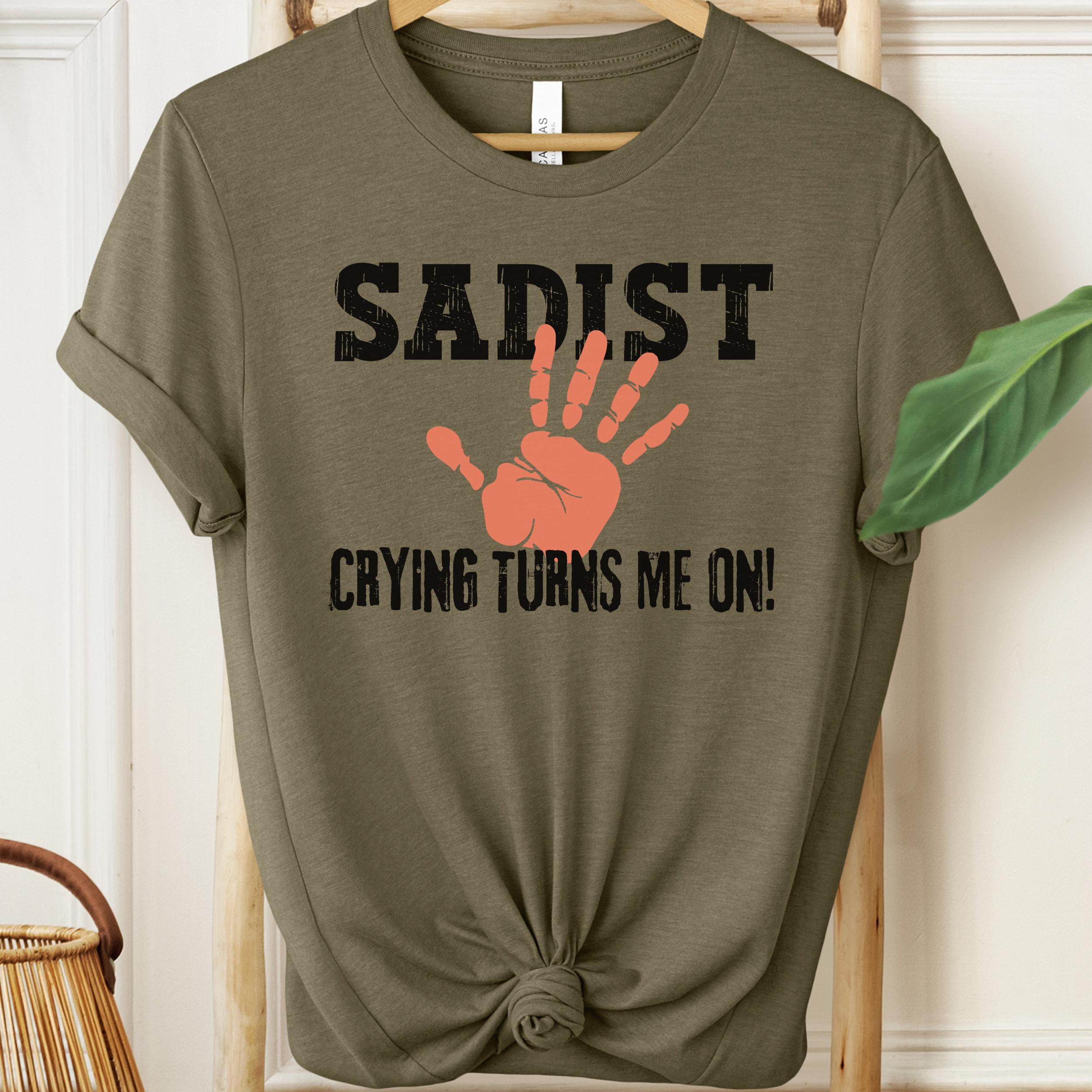 Olive green t-shirt with SADIST CRYING turns me on! text and hand graphic on a hanger.