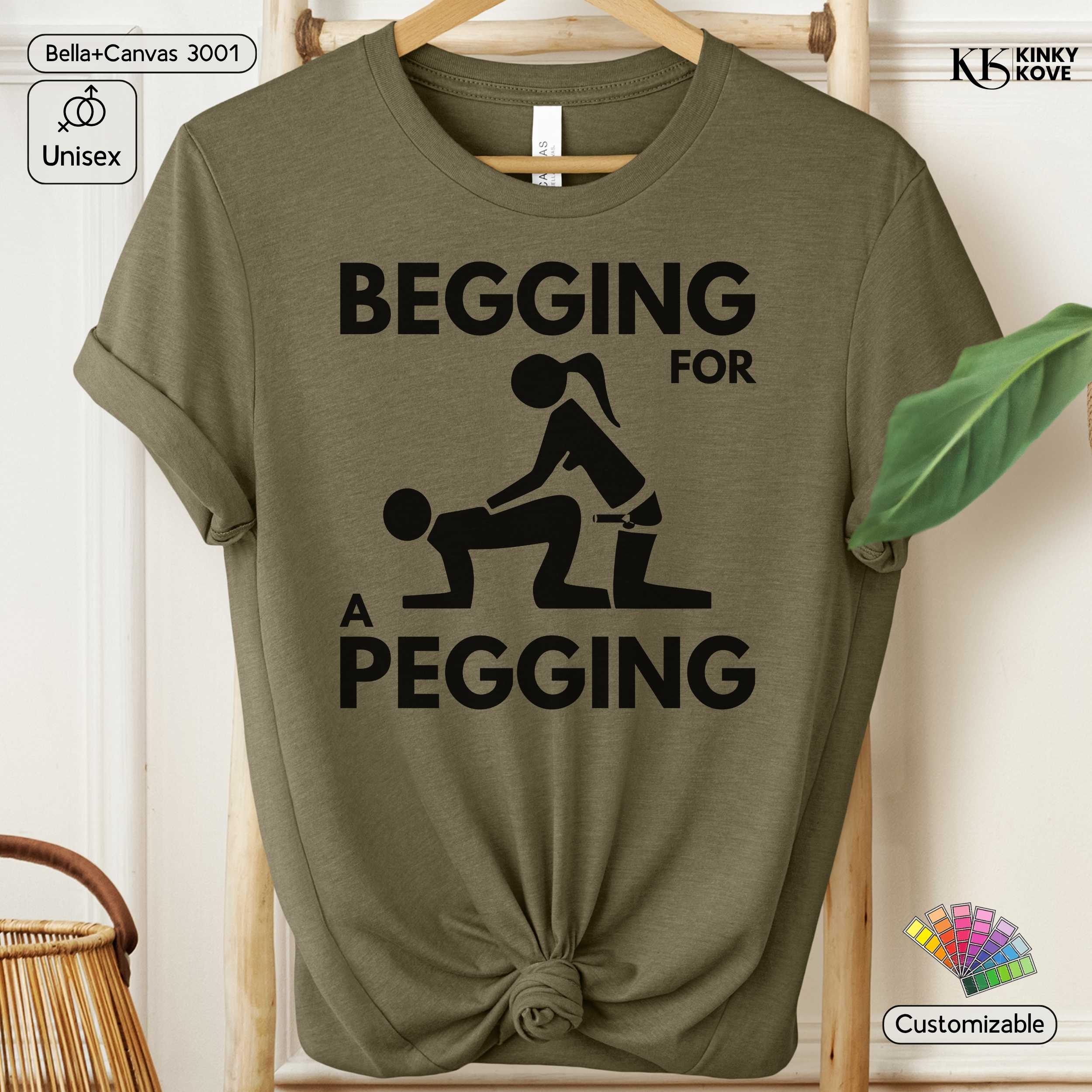 Green t-shirt with graphic design and text on a hanger